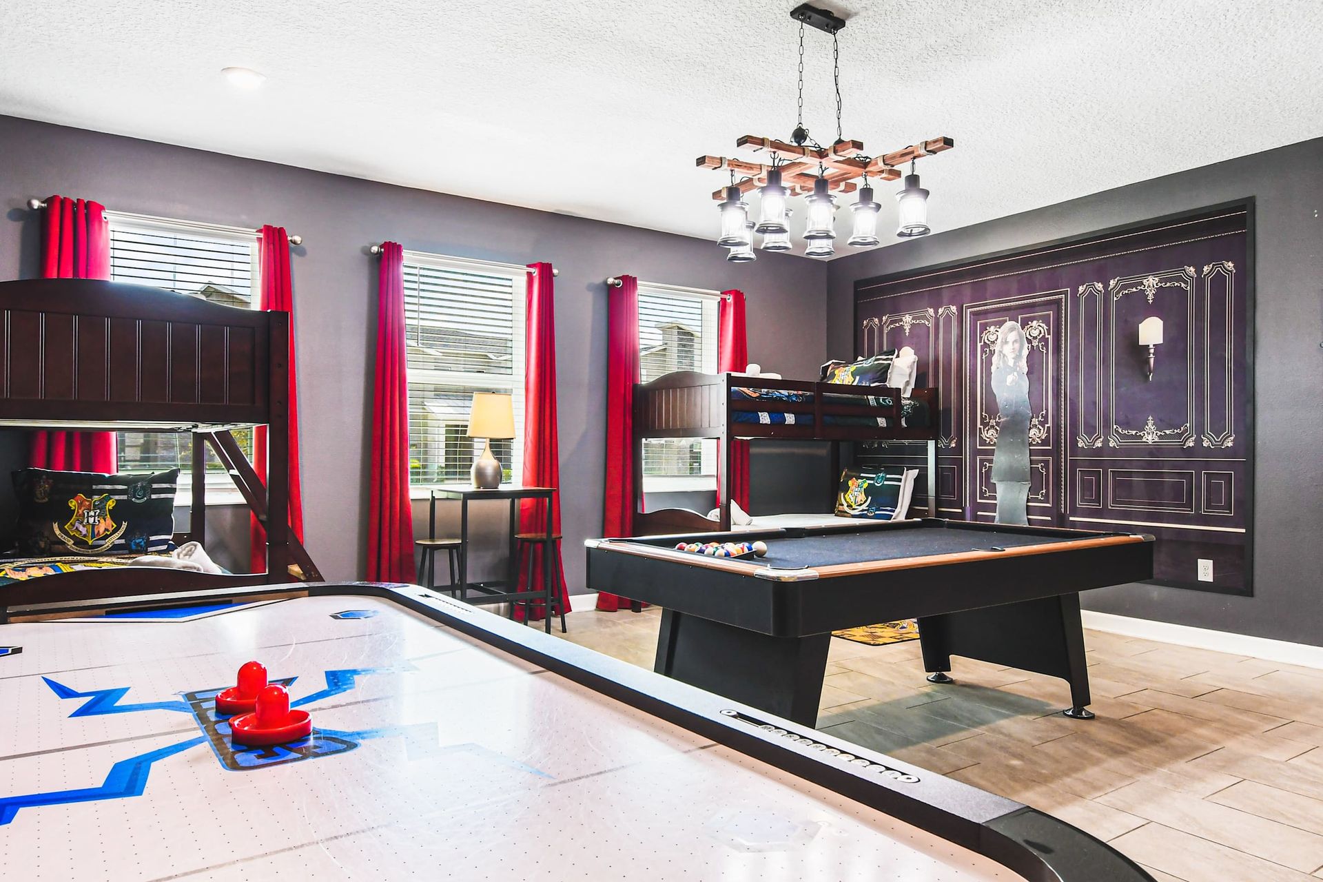 Enchanting game room with wizard decor, bunk beds, pool table and air hockey
