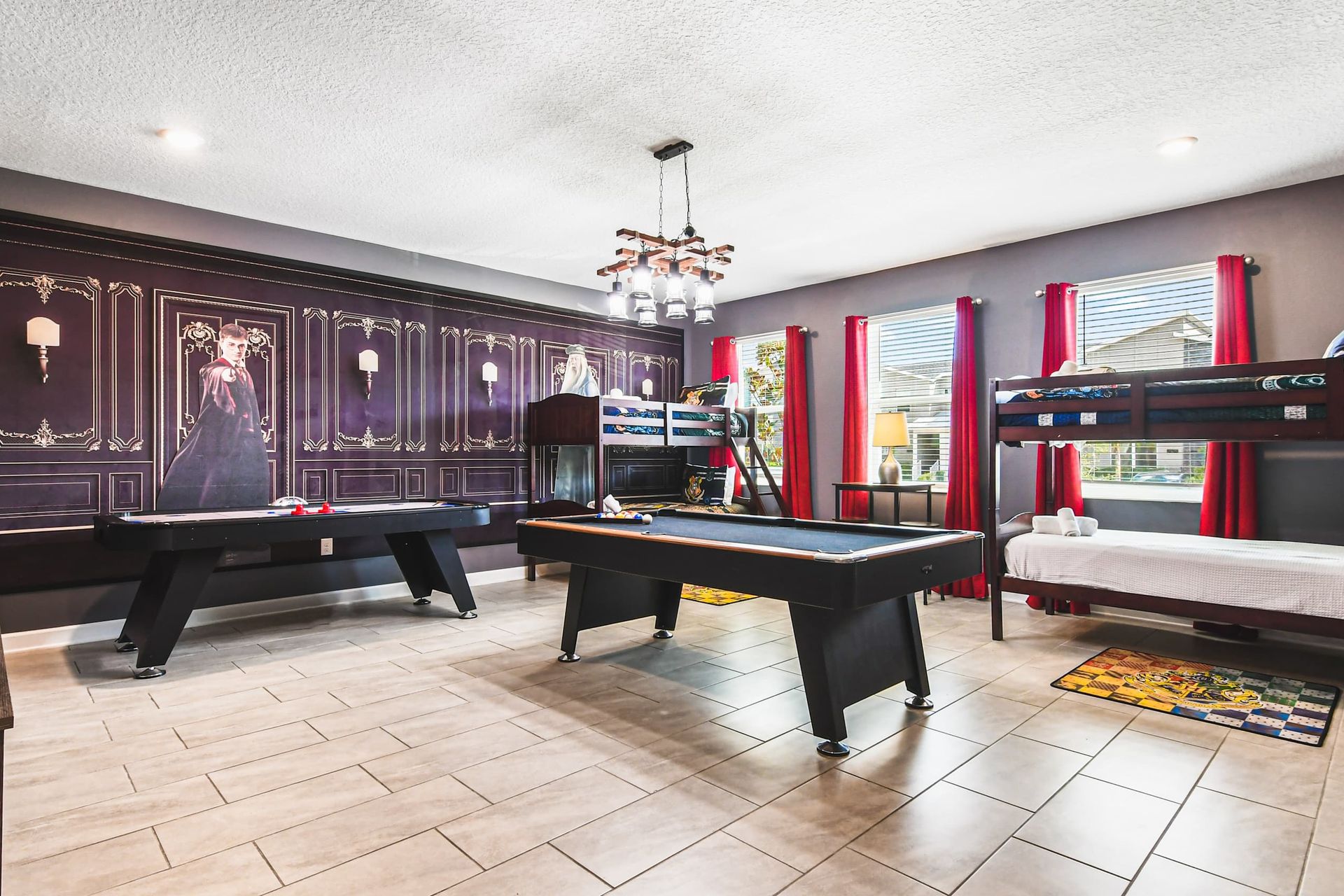 Enchanting game room with wizard decor, bunk beds, pool table and air hockey
