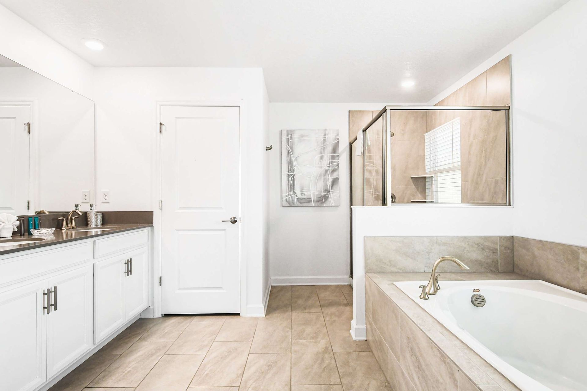 Spacious master bath with soaking tub, walk-in shower, double sinks and elegant decor
