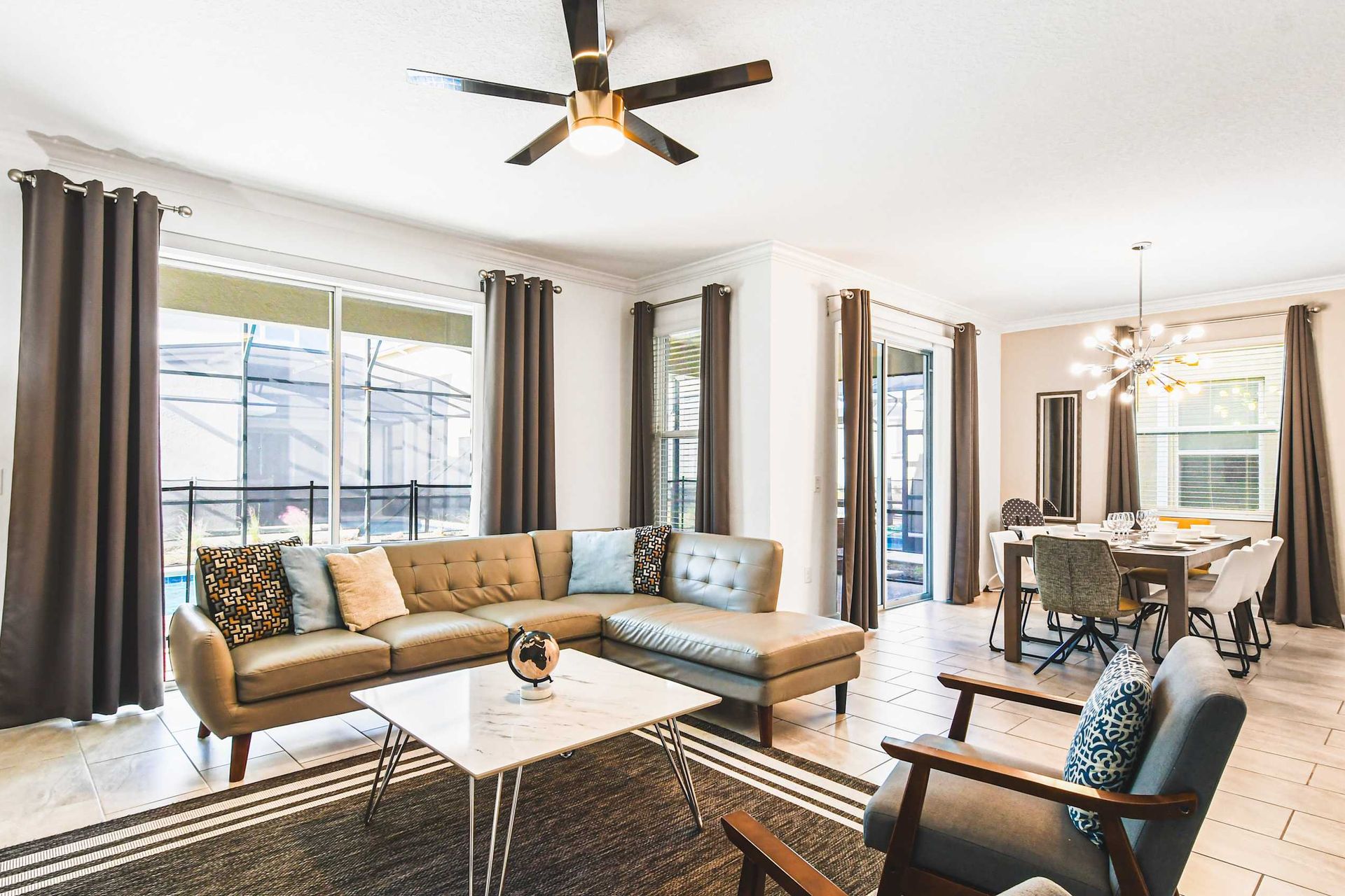 Open-concept living and dining with modern style, great light, and pool views