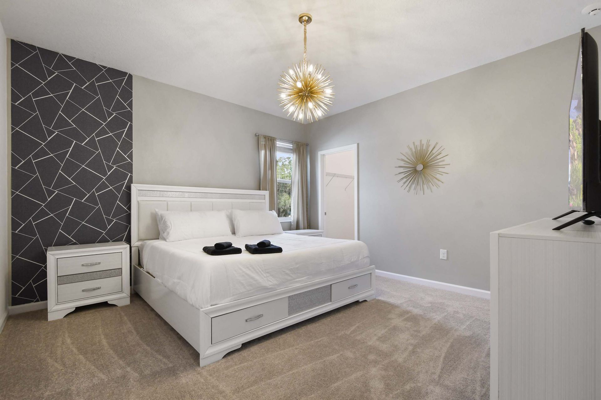 Modern elegance with soft hues, gold accents, and a chic lighted vanity.