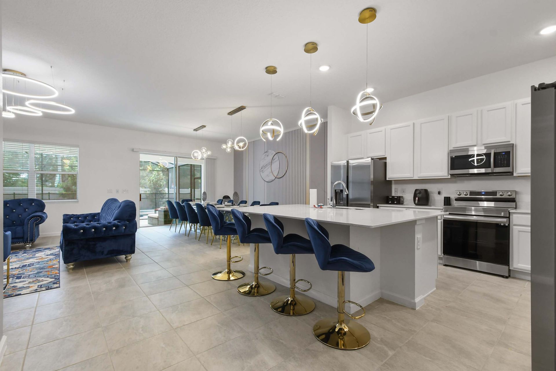 Spacious open-concept kitchen and lounge with chic lighting and ample seating.