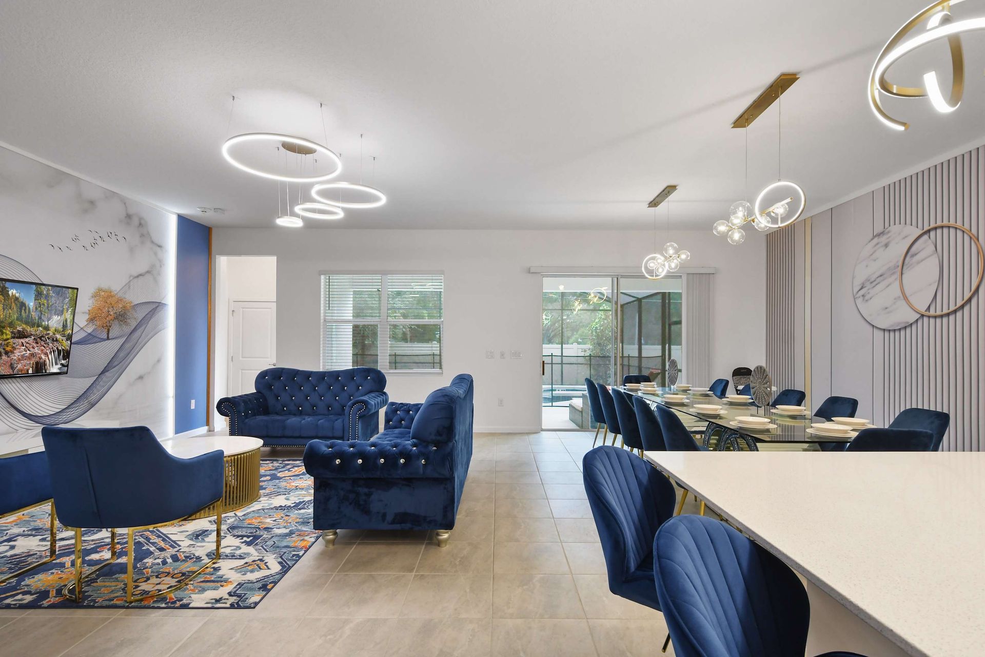 Stylish open living area with plush seating, modern lighting, and pool access.