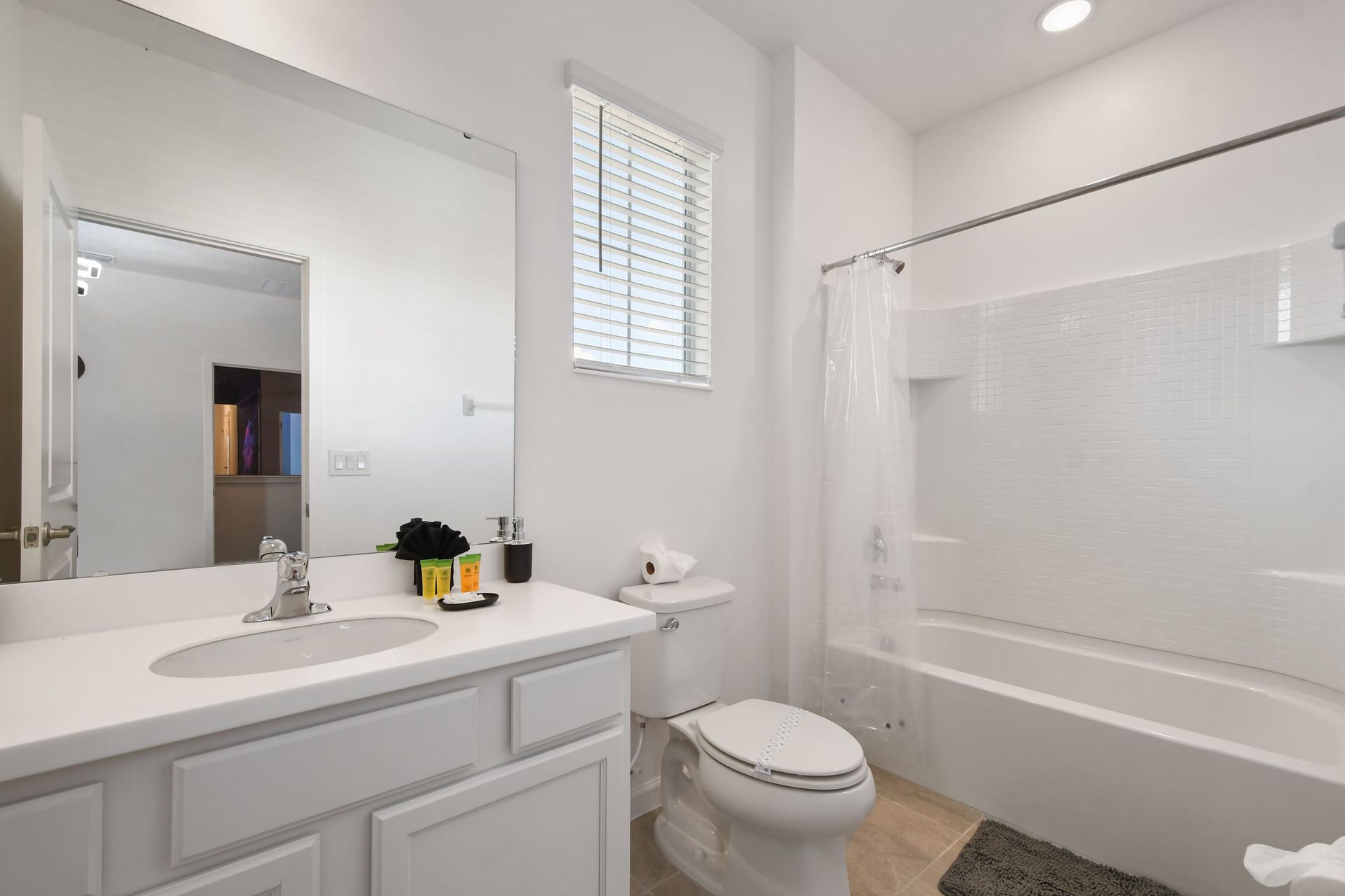Bright and spotless bathroom with a clean tub and modern white finishes.