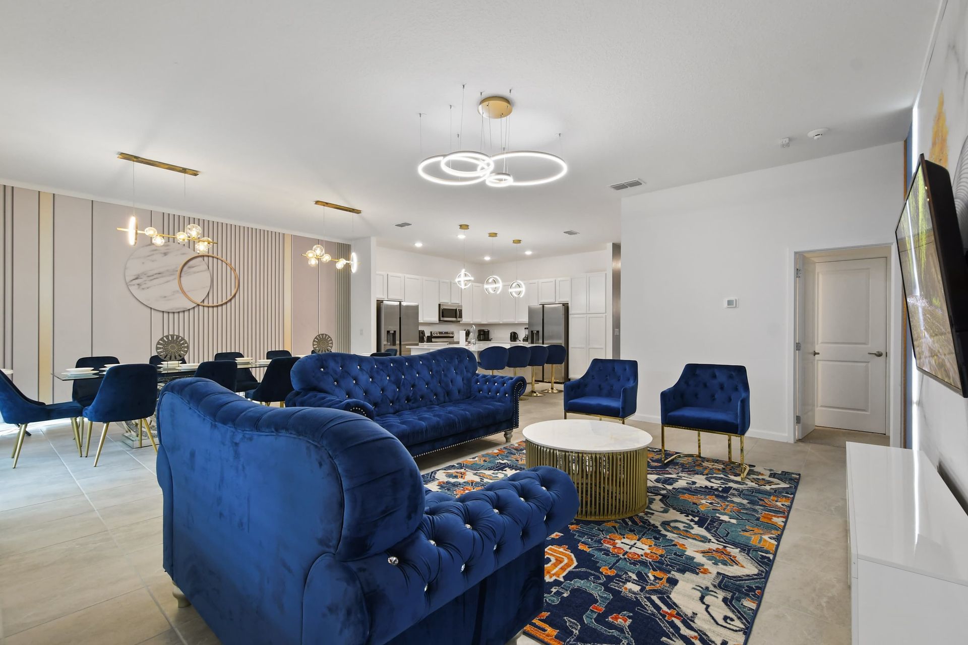 Spacious open-concept living area with plush seating, modern decor, and dining.