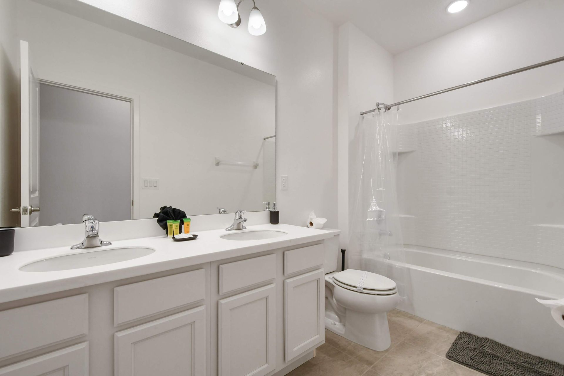 Bright and spotless bathroom with a clean tub and modern white finishes.
