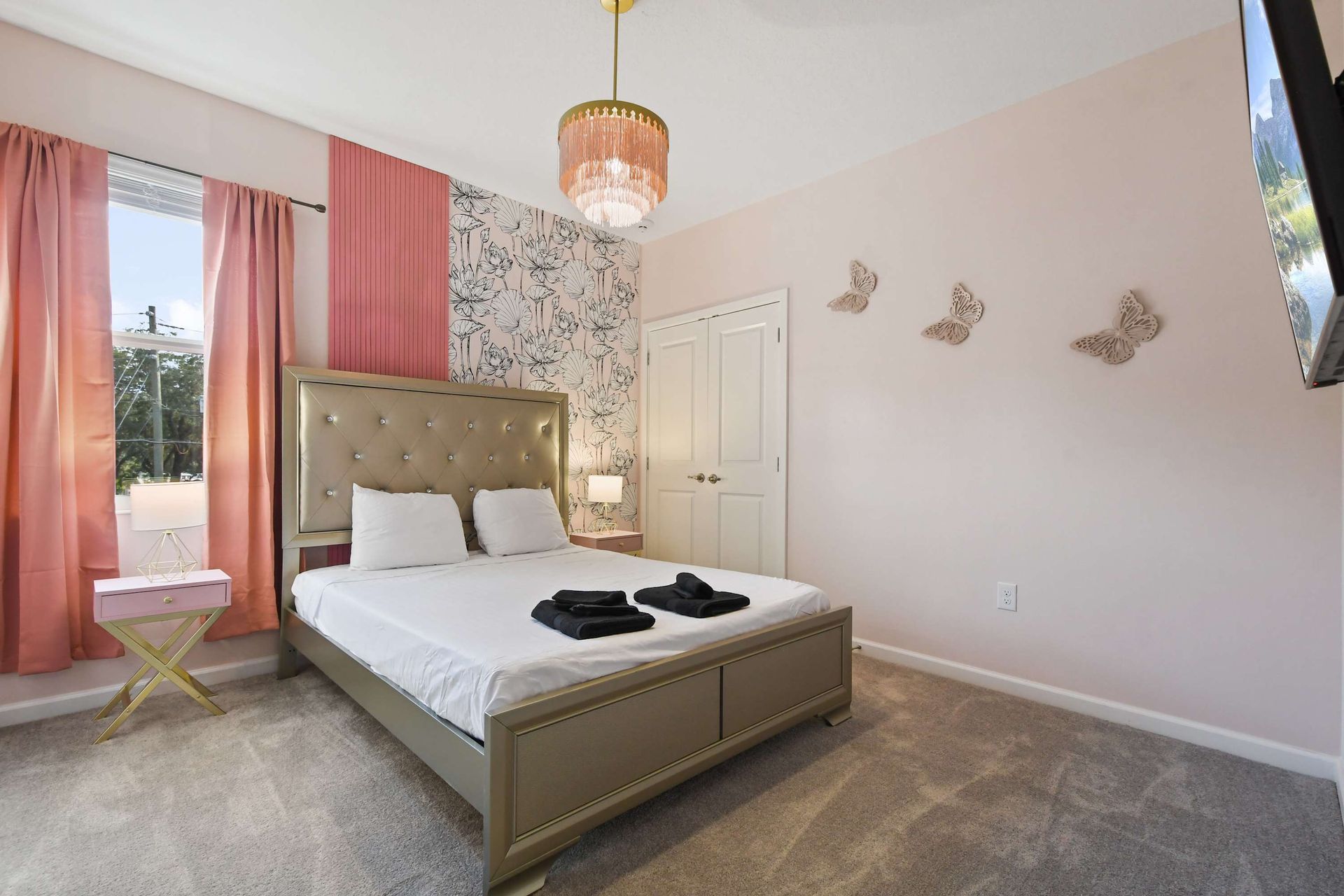 Charming bedroom with soft pastels, gold accents, and a vanity—elegant and cozy