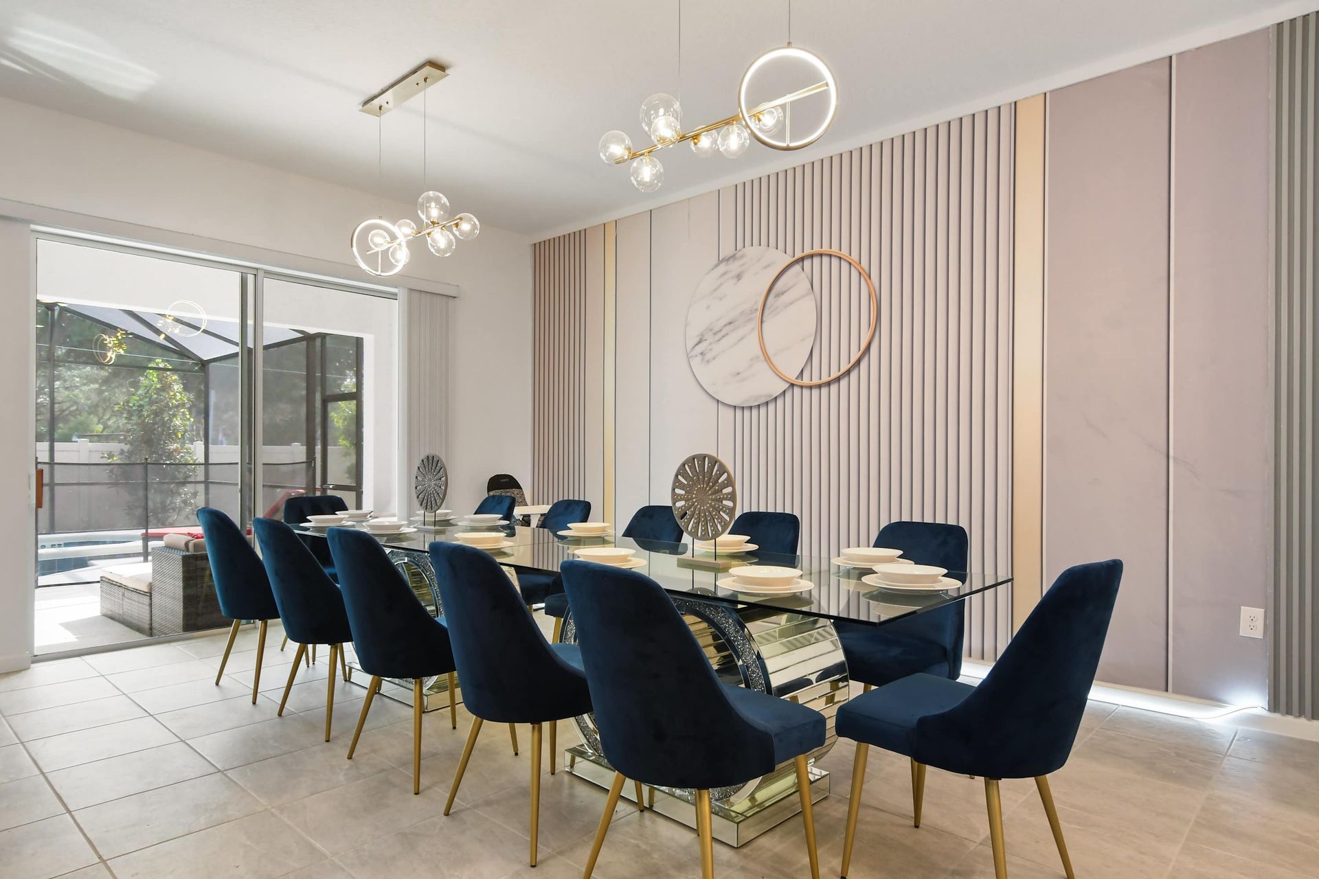 Elegant dining area with modern decor, seating for 12, and poolside views.