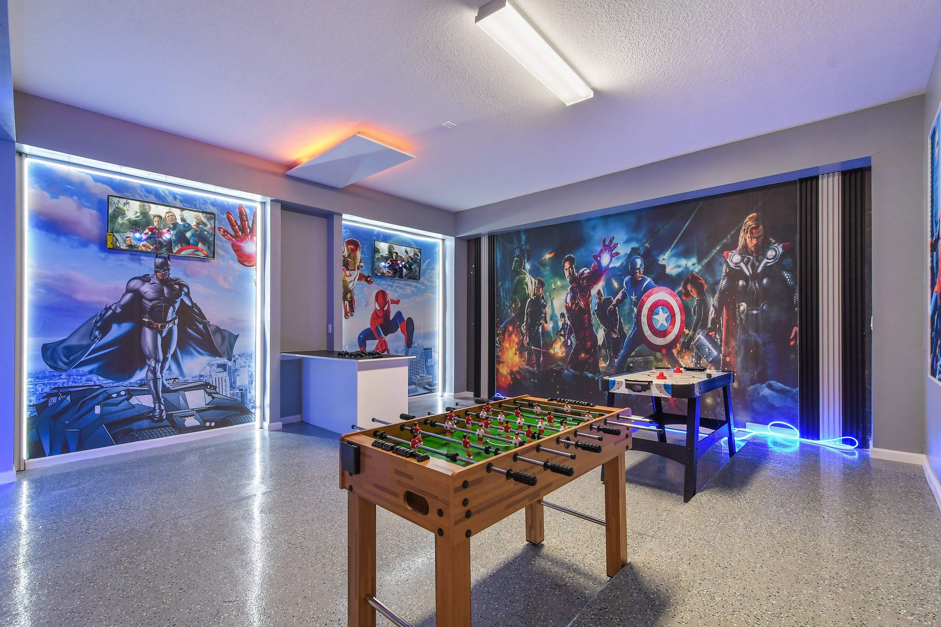 Epic game room with Spiderman murals, neon lighting, and arcade-style fun.