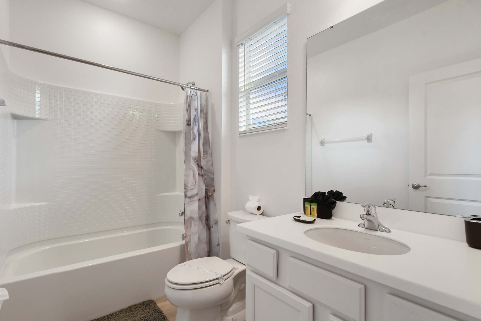 Bright and spotless bathroom with a clean tub and modern white finishes.