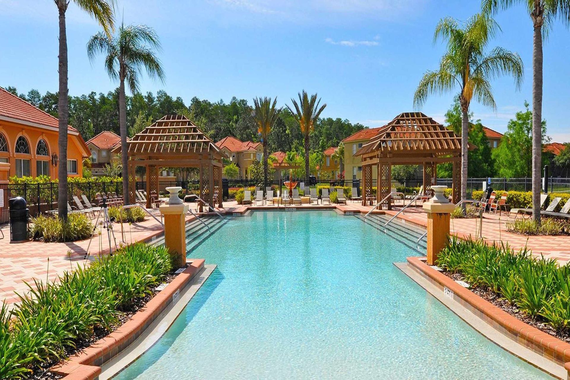 Luxurious poolside retreat with cabanas, loungers, and palm views!