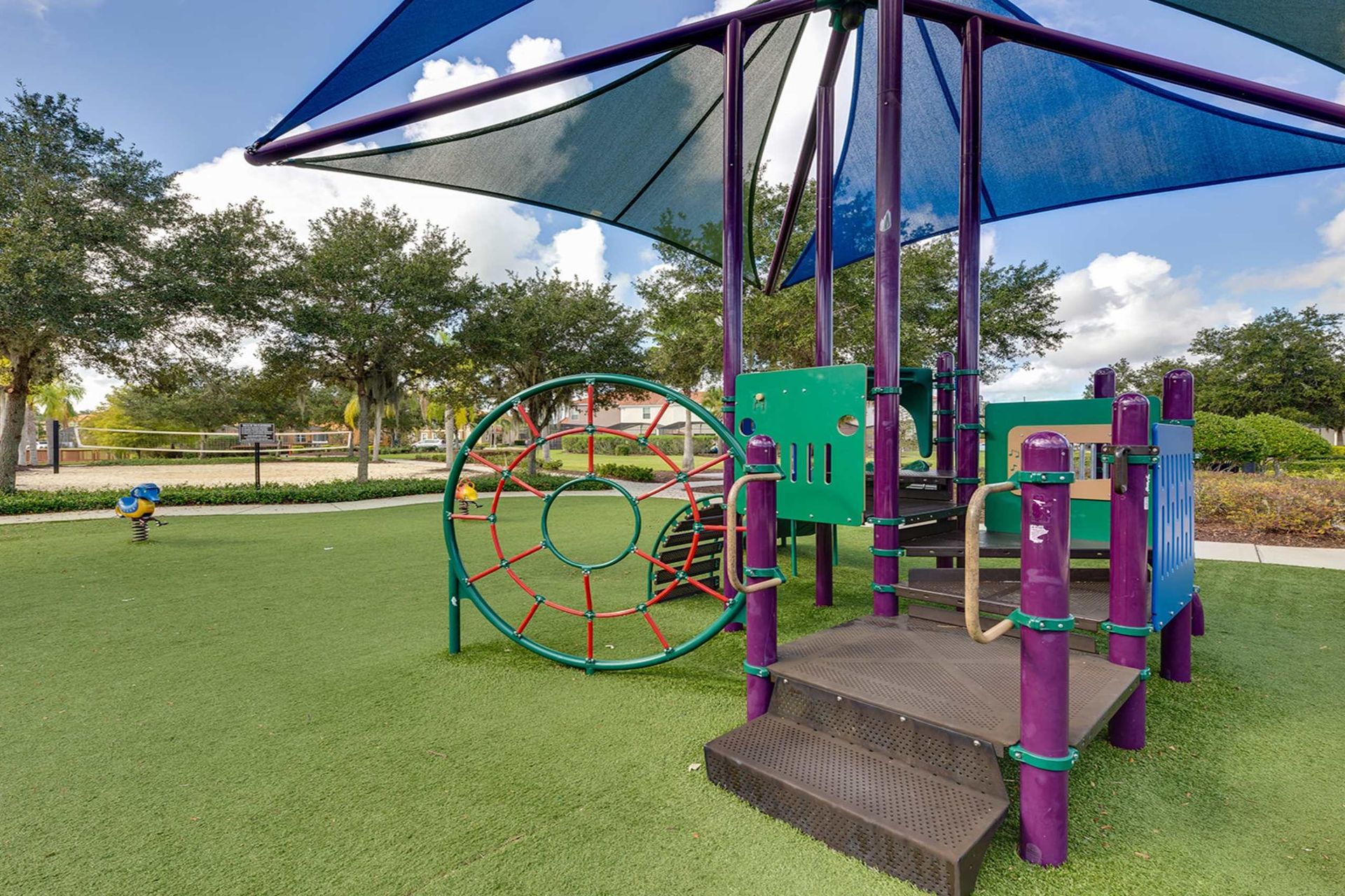 Family fun! Shaded playground & nearby volleyball court await!