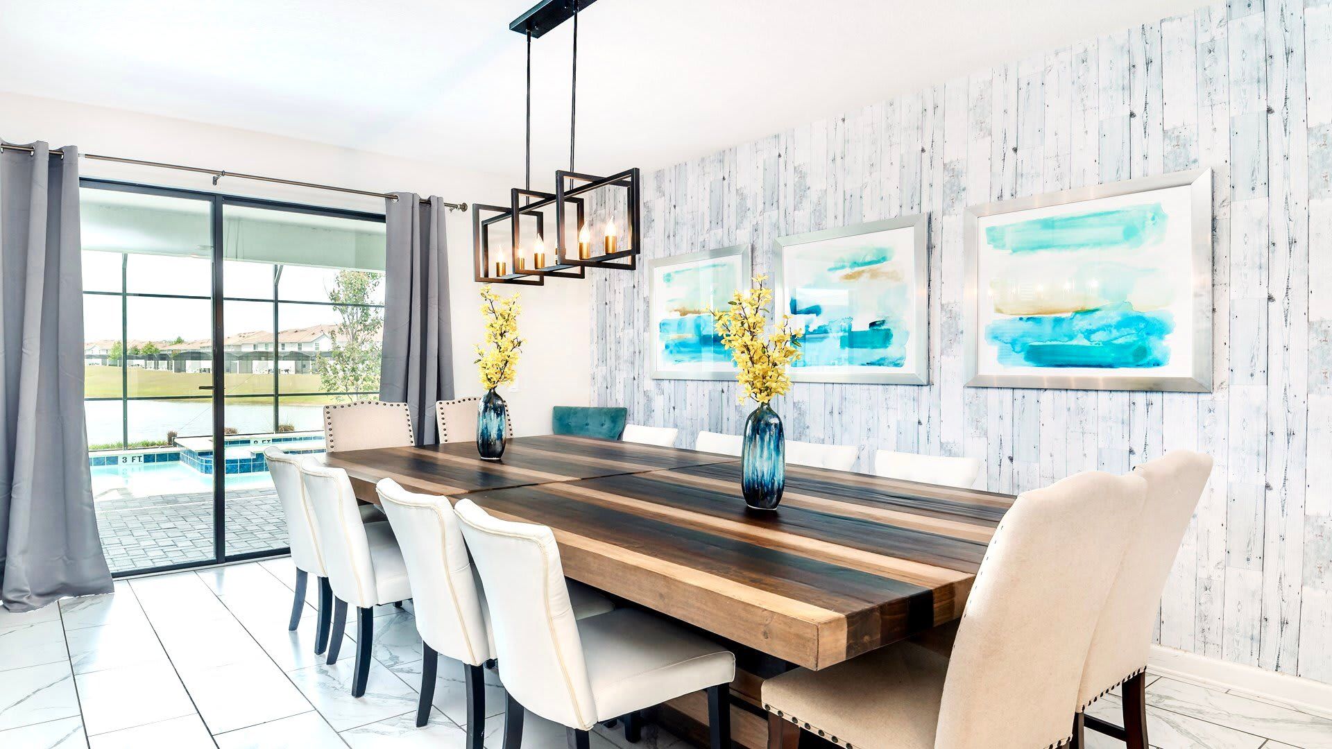 Elegant dining room with seating for twelve, pool views, and modern lighting