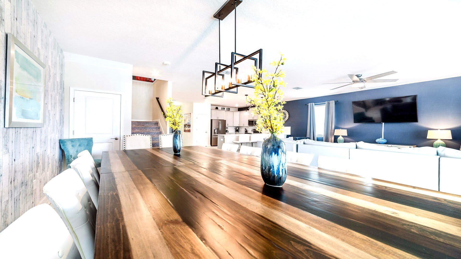 Stylish open layout with gourmet kitchen, oversized dining table, and chic decor