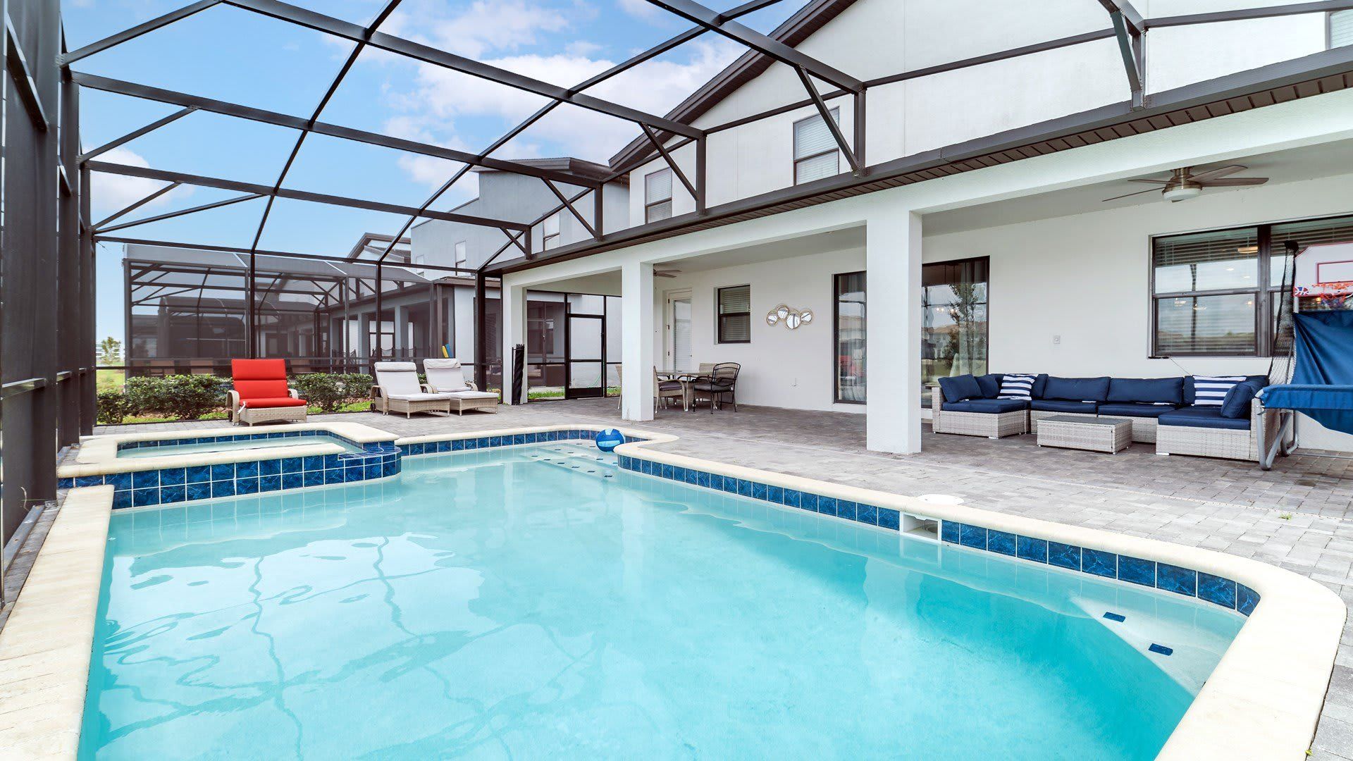 Spacious screened patio with private pool, spa, lounge seating, and alfresco dining