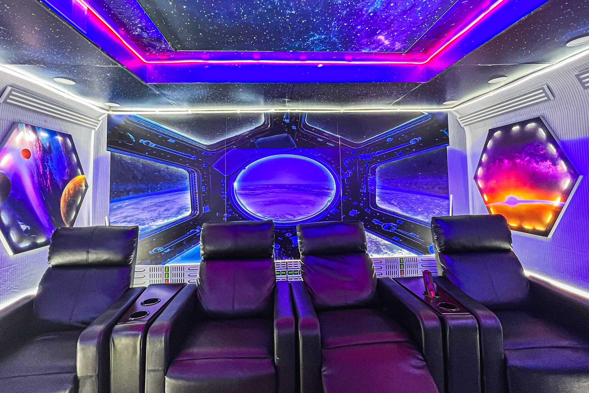 Galactic-themed theater with LED lights, starry ceiling, and ultra-comfy recliners