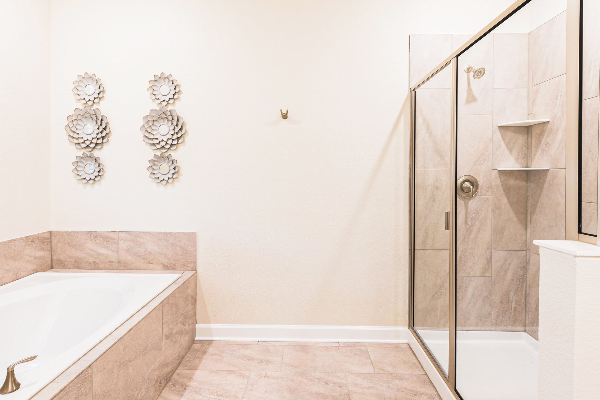 Spa-inspired bathroom with soaking tub, glass walk-in shower, and elegant tile finishes