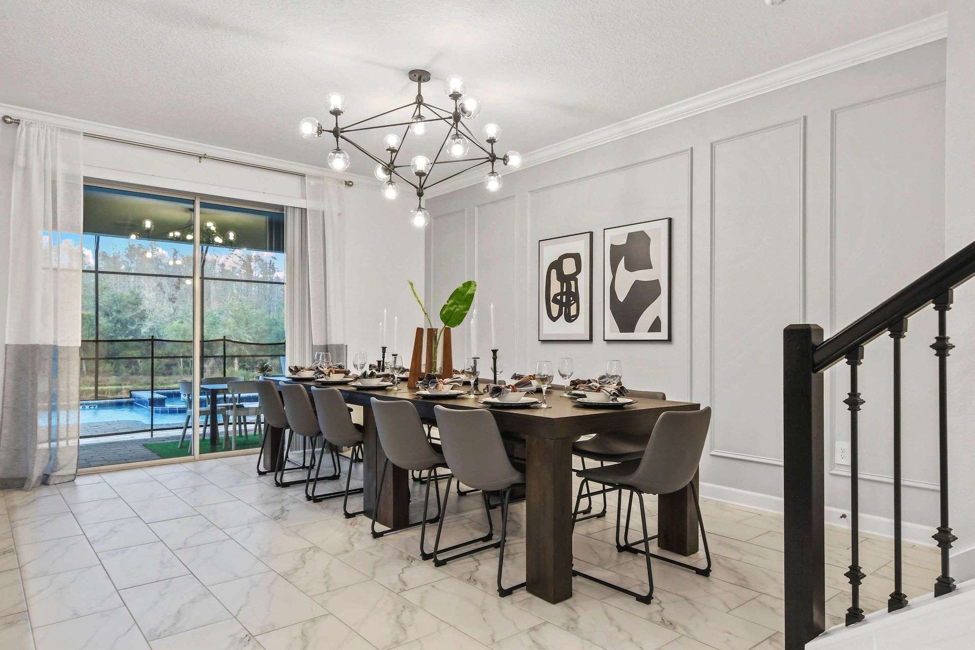 Modern dining room with seating for 10, chic décor, and poolside views.
