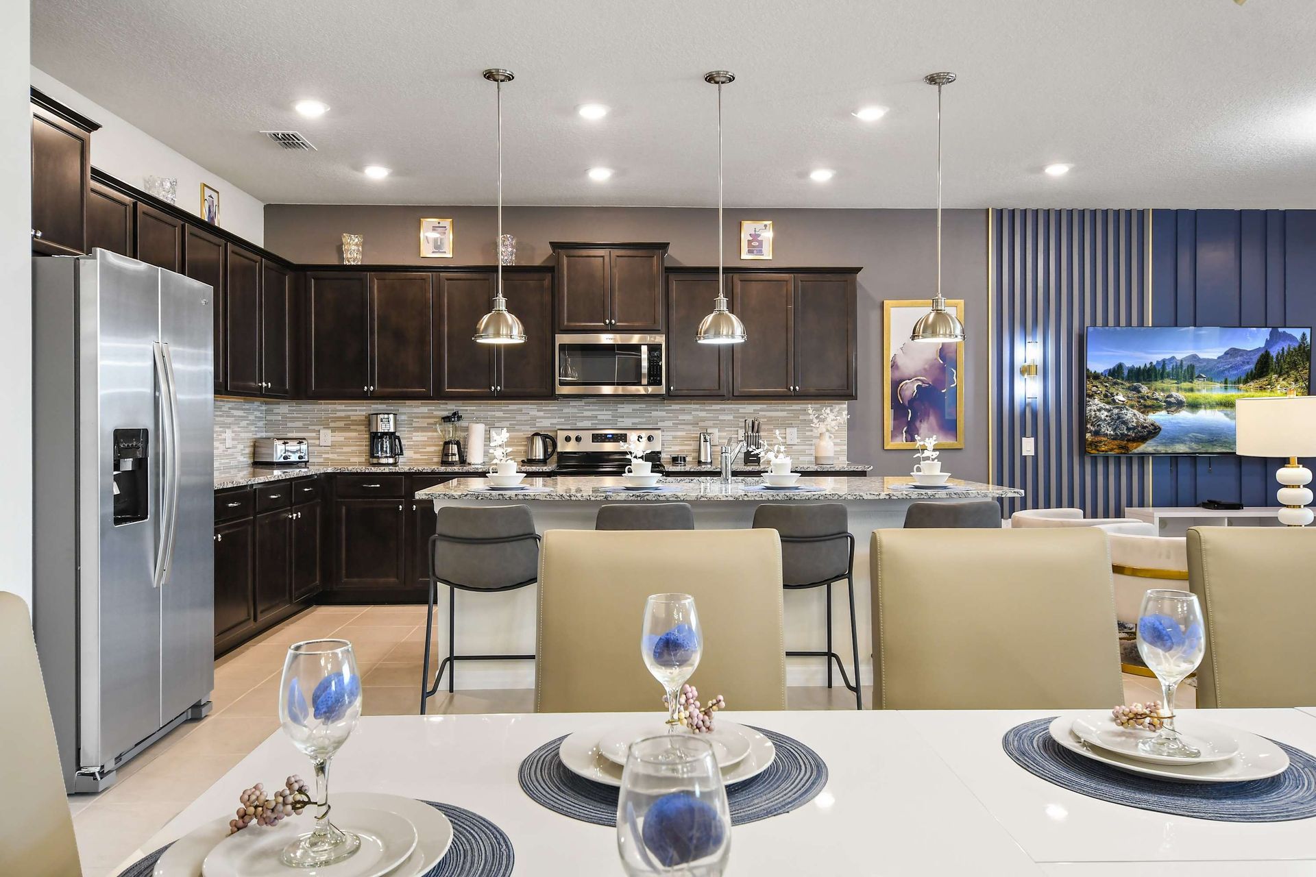 Spacious designer dining room with seating for 16 and statement modern lighting
