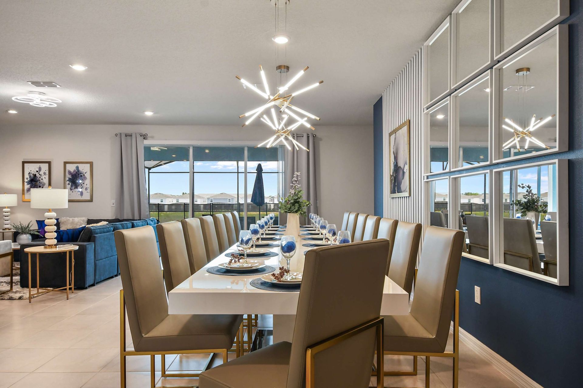 Spacious designer dining room with seating for 16 and statement modern lighting