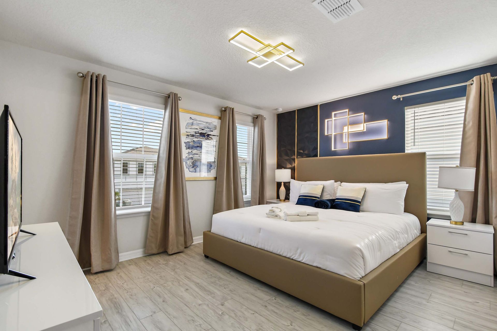 Sophisticated bedroom with king bed, ambient lighting, and elegant navy accents