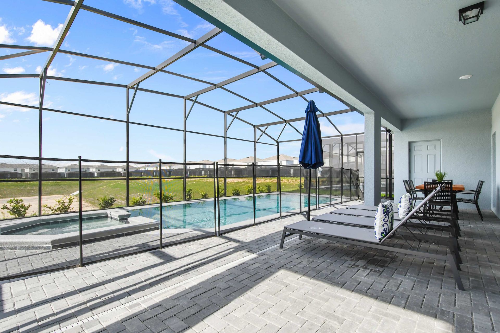 Covered patio with dining for eight, poolside loungers, and seamless indoor access