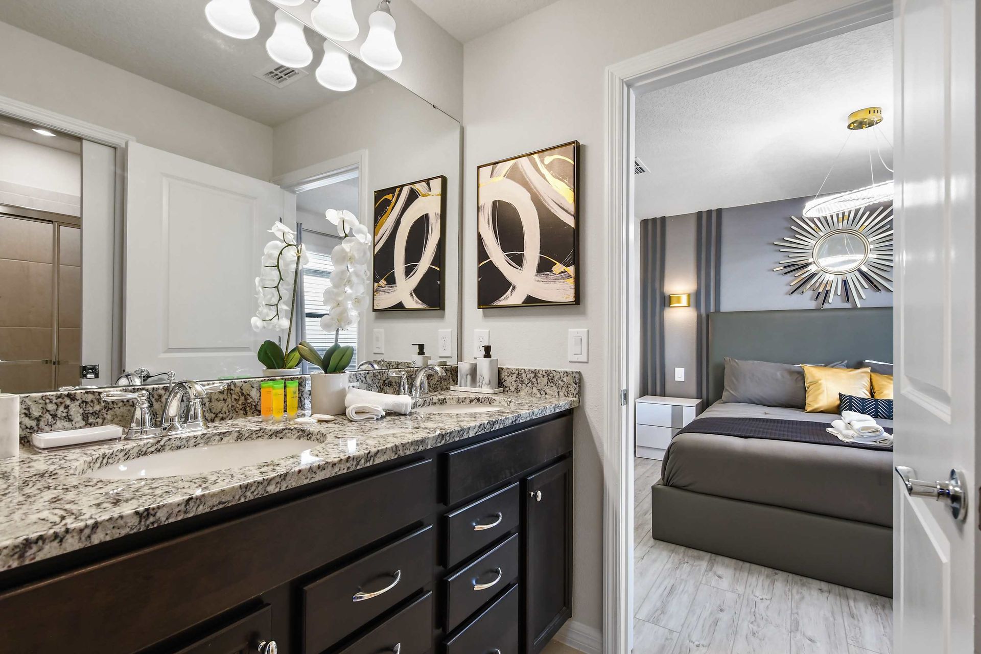 Elegant ensuite bathroom with granite dual vanity, walk-in shower, and modern décor