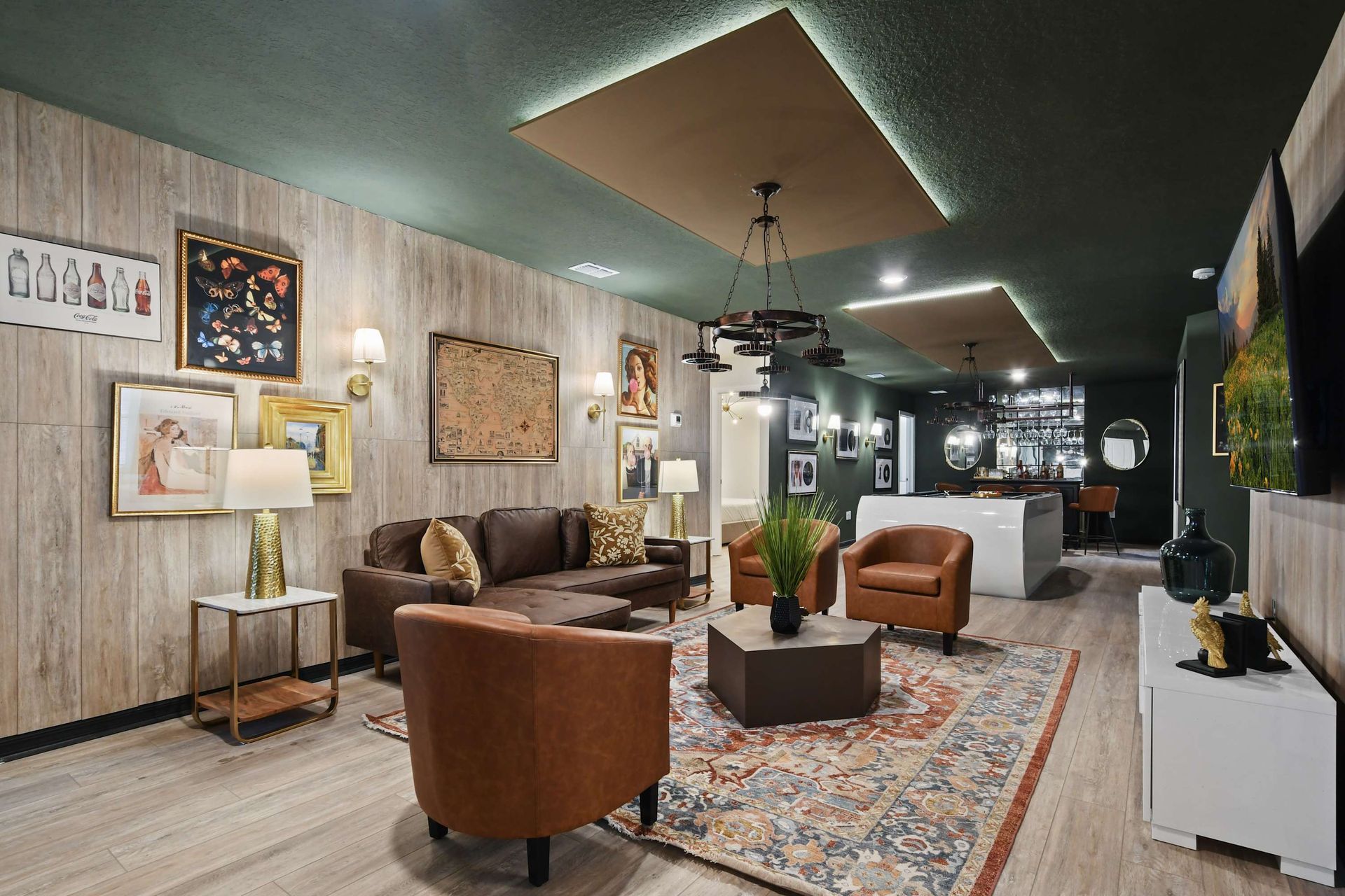 Spacious lounge with vintage art, cozy seating, and a bar for entertaining guests.