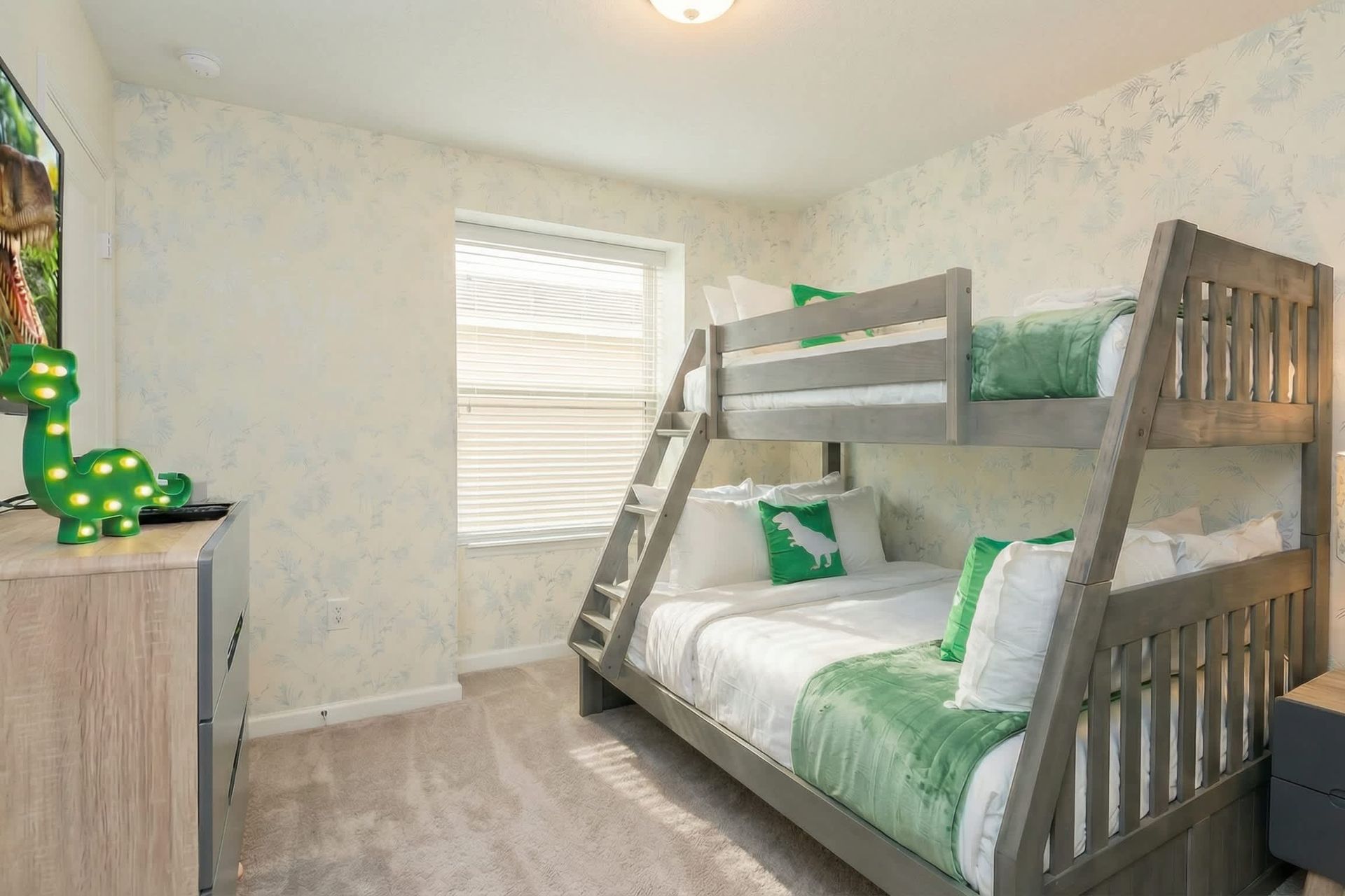 Dino-themed bunk room with cozy vibes, perfect for little adventurers' stay.