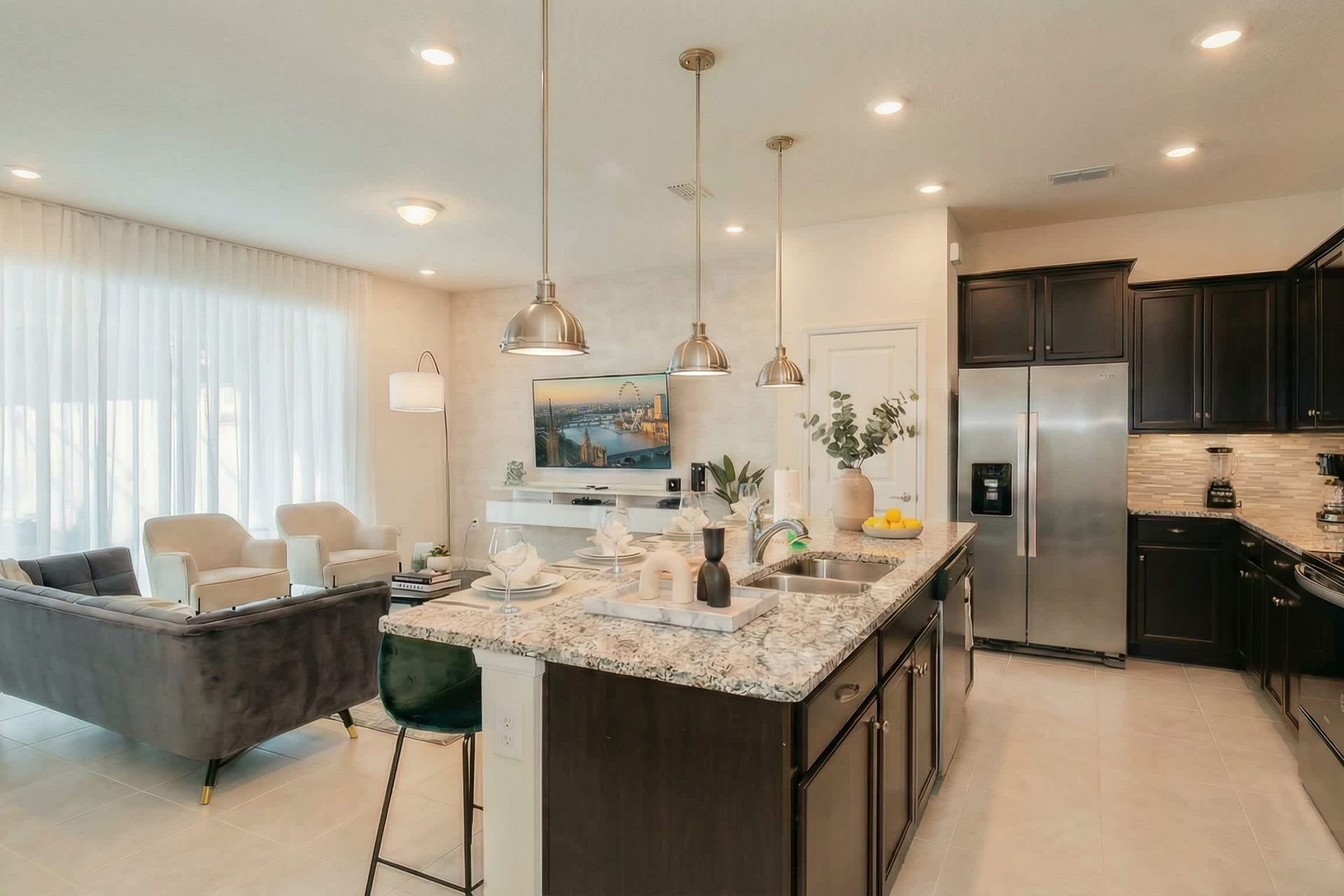 Spacious open kitchen and living area with upscale finishes and natural light.
