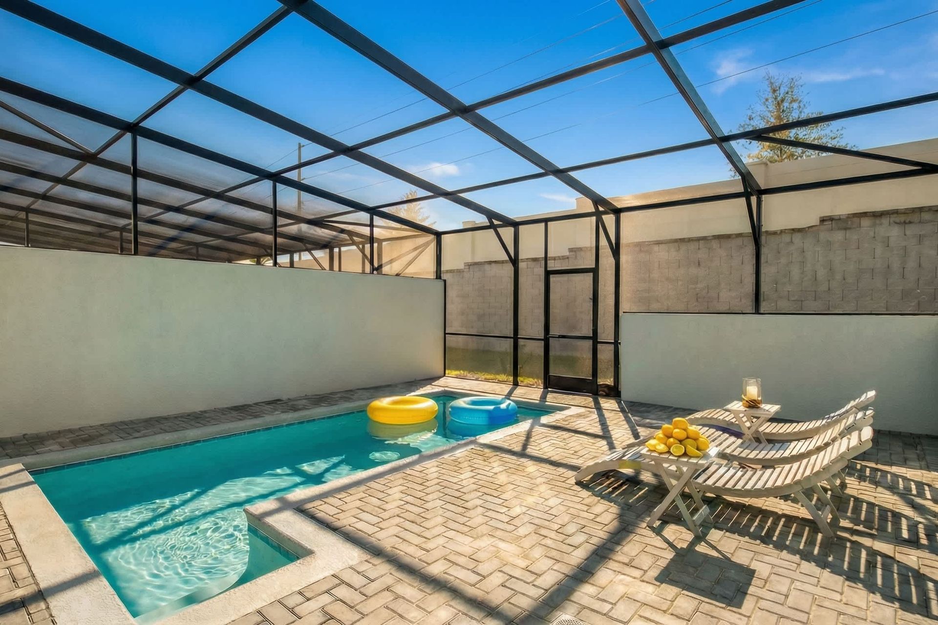 Relax in your private screened-in pool oasis with loungers and outdoor dining.
