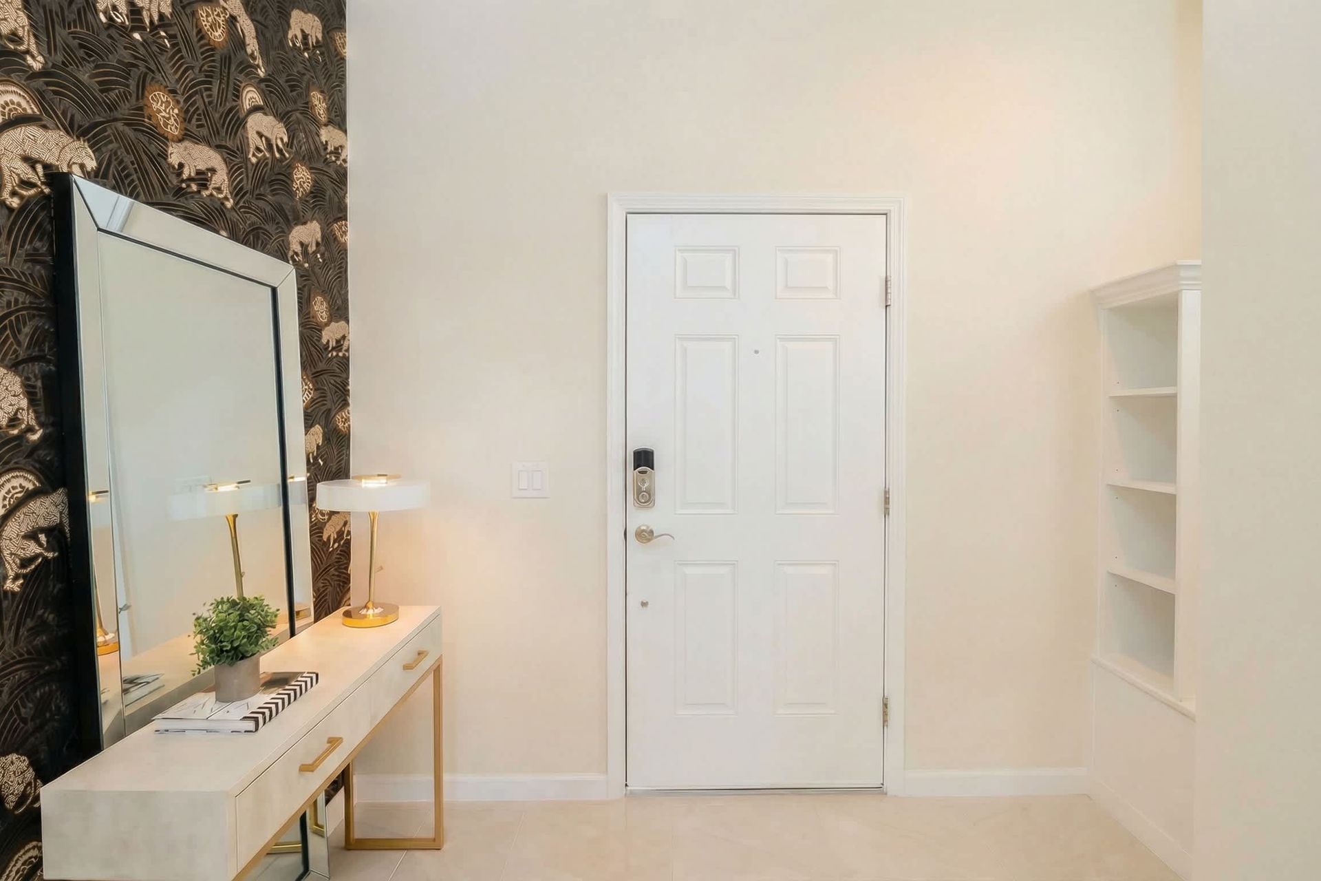 Stylish entryway with bold wallpaper, elegant console, and welcoming vibe.