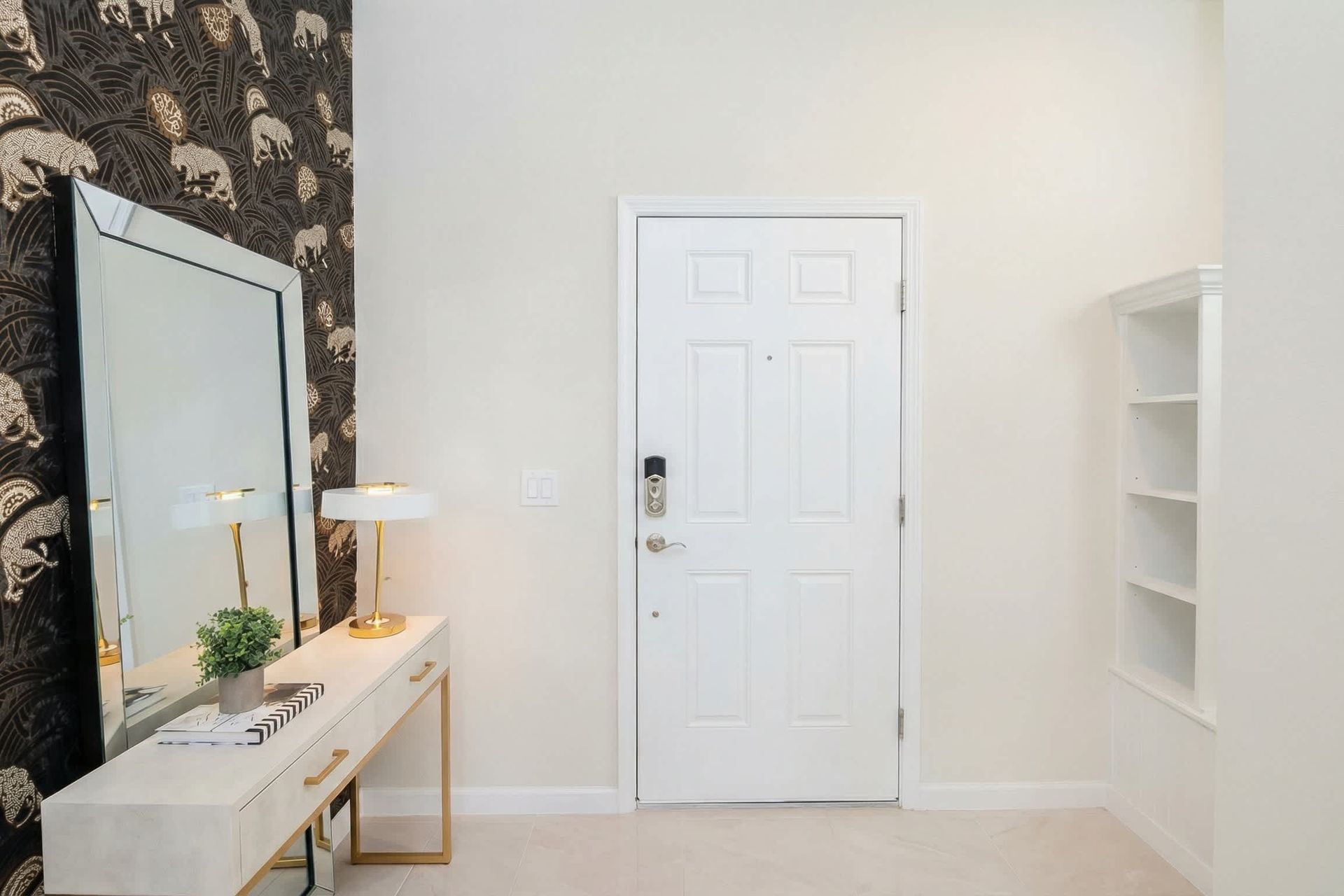 Stylish entryway with bold wallpaper, elegant console, and welcoming vibe.