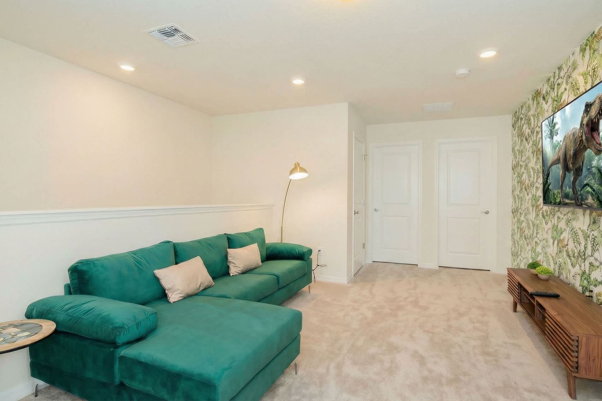 Tropical-themed loft with plush sectional and big-screen TV for movie nights.