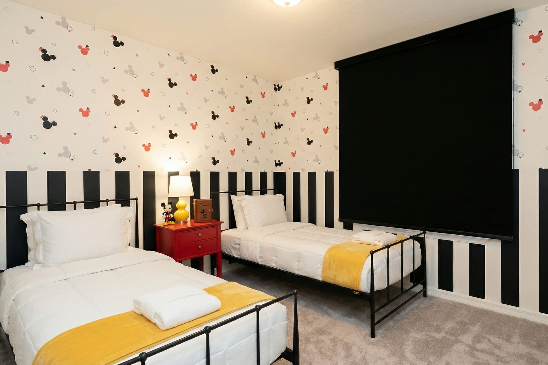 Playful twin room with bold stripes, fun decor, and cozy bedding for kids.