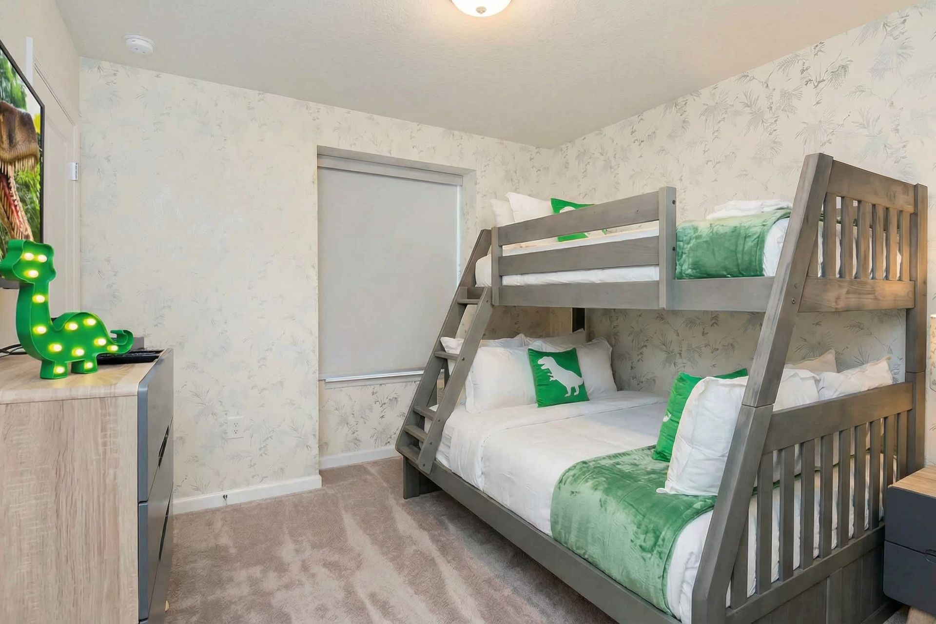 Dino-themed bunk room with cozy vibes, perfect for little adventurers' stay.
