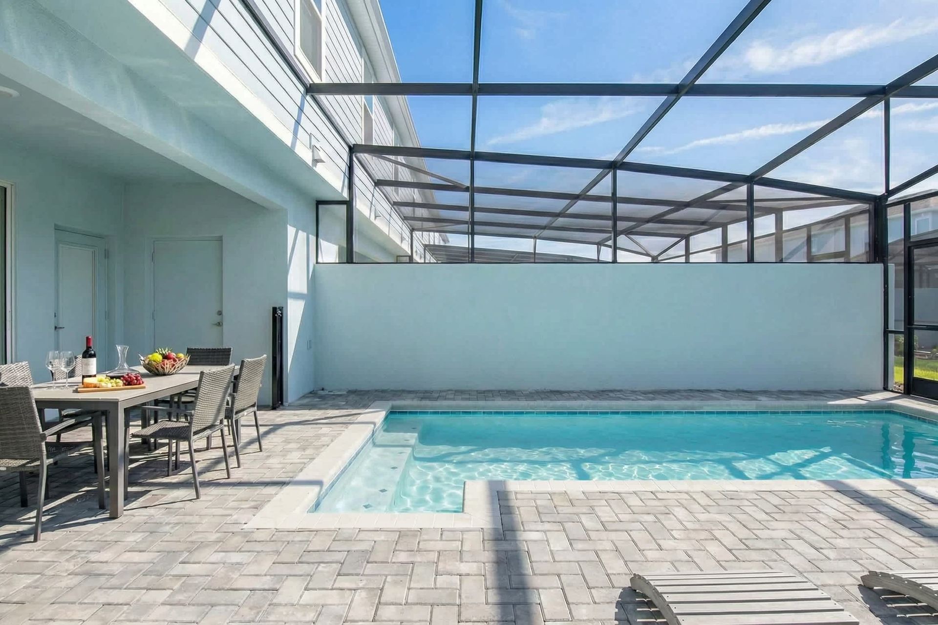 Relax in your private screened-in pool oasis with loungers and outdoor dining.
