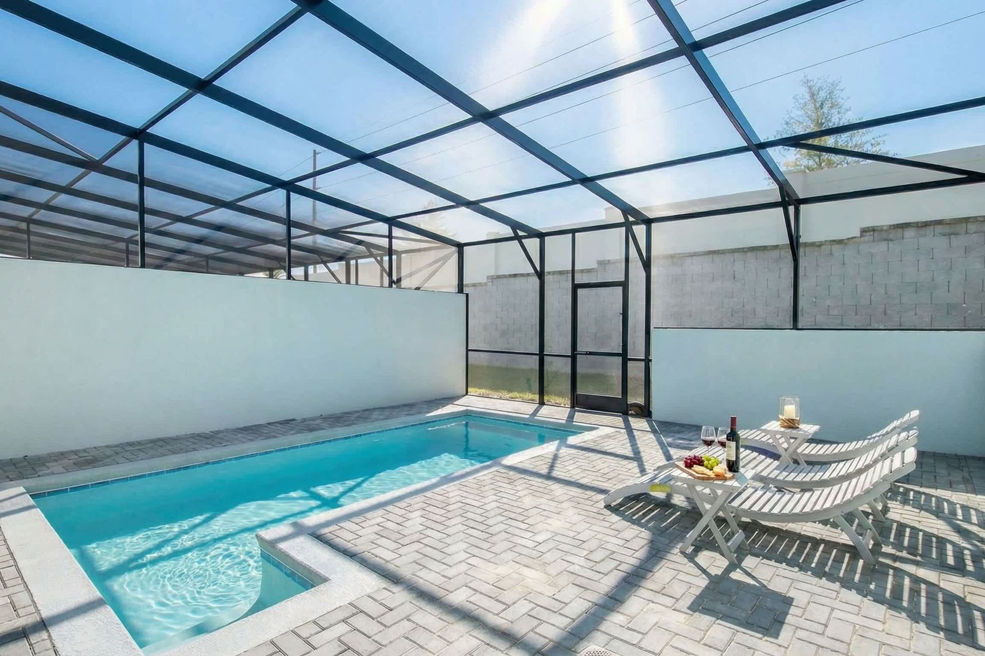 Relax in your private screened-in pool oasis with loungers and outdoor dining.