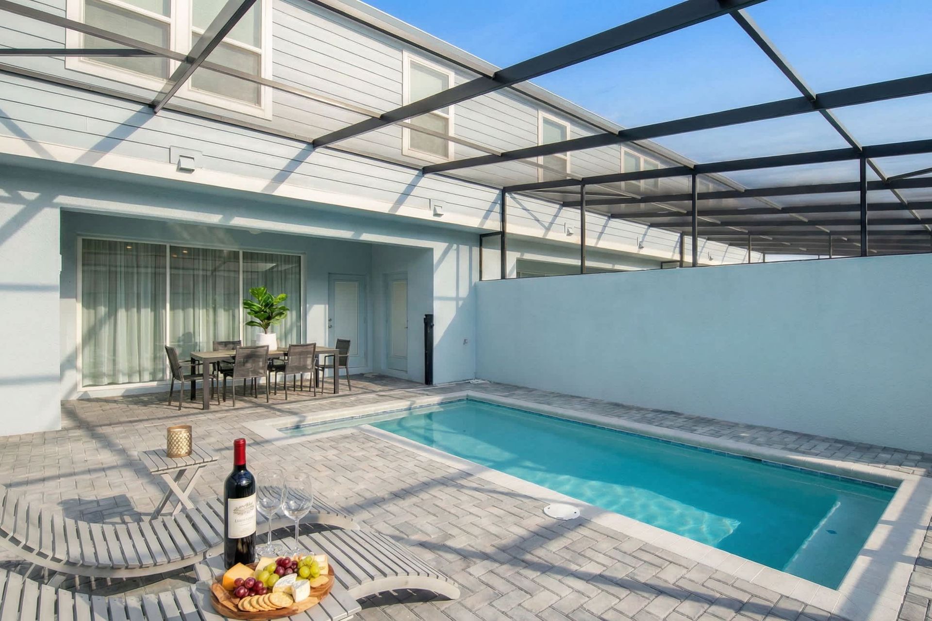 Relax in your private screened-in pool oasis with loungers and outdoor dining.