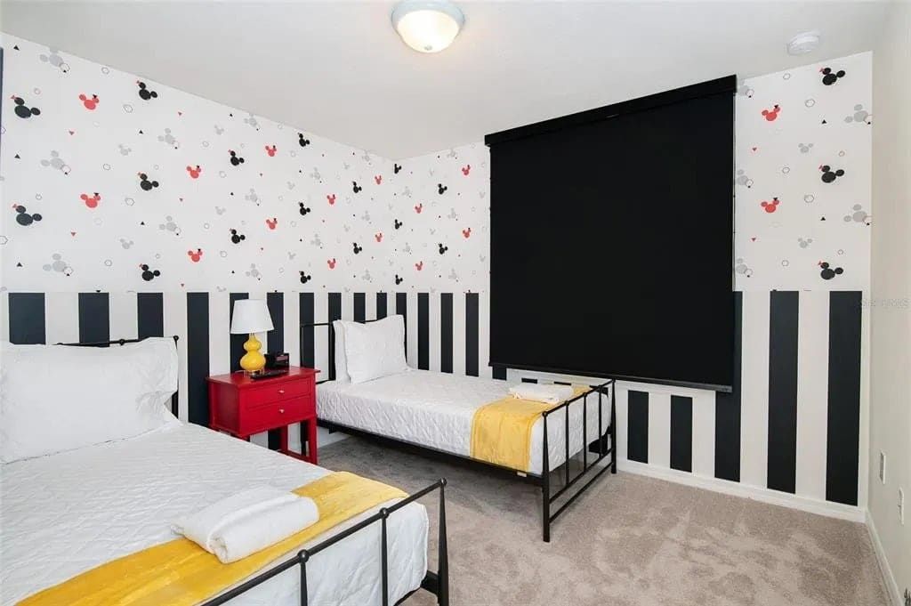 Playful twin room with bold stripes, fun decor, and cozy bedding for kids.