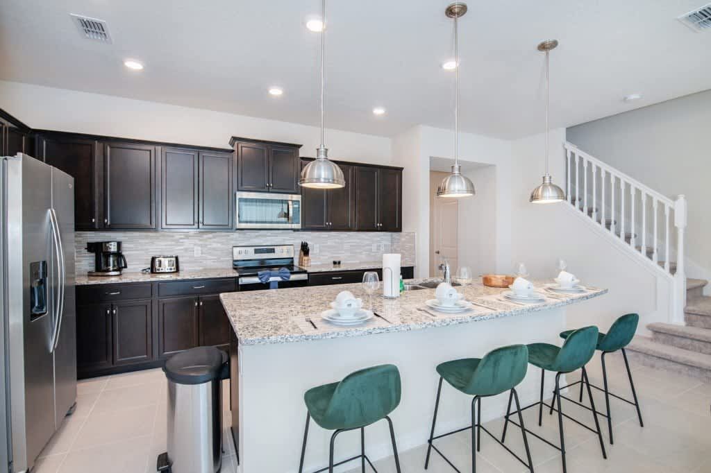 Gourmet kitchen with granite counters, sleek appliances, and stylish seating.