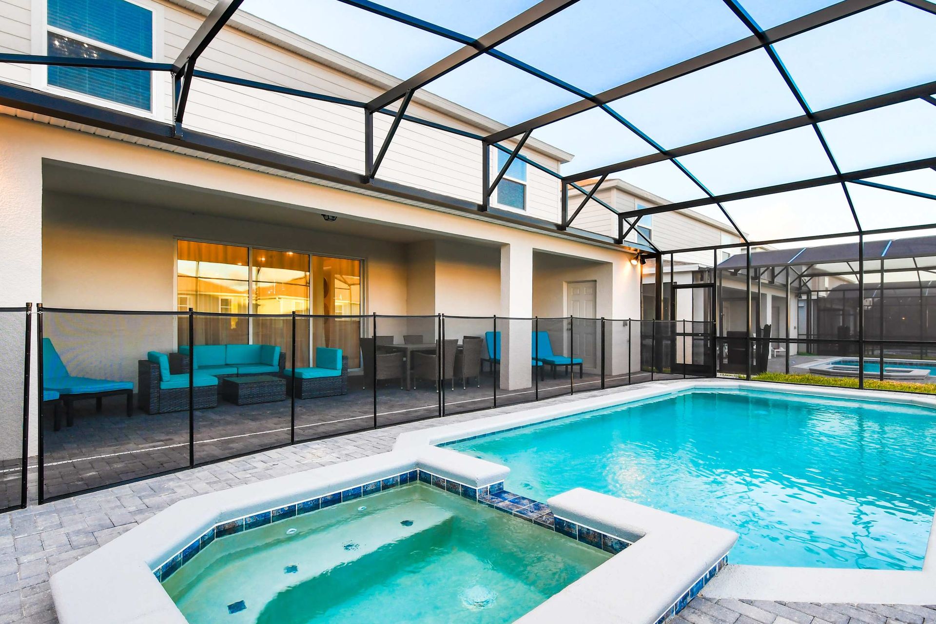 Private screened pool and spa with comfy lounge seating and shaded patio area
