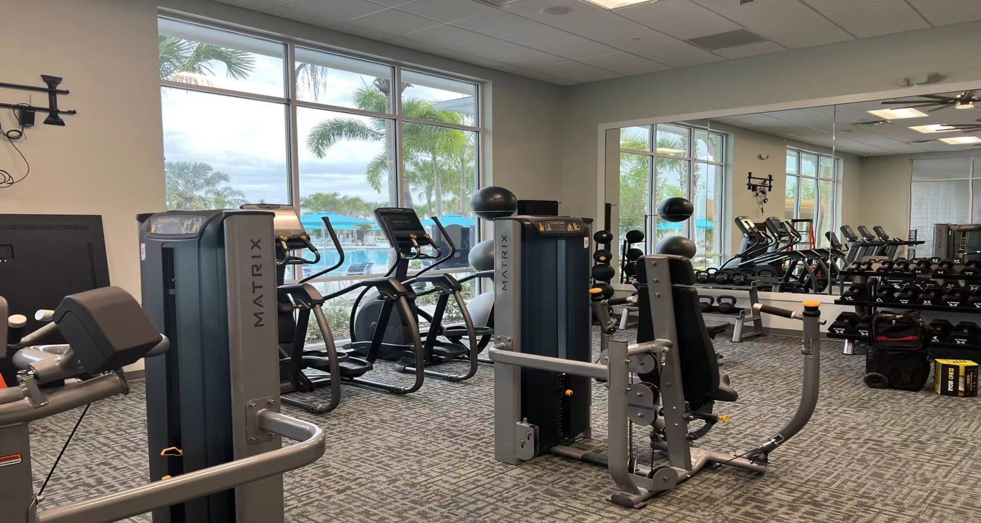 Enjoy your workouts with a view! Bright, modern gym overlooking resort amenities.