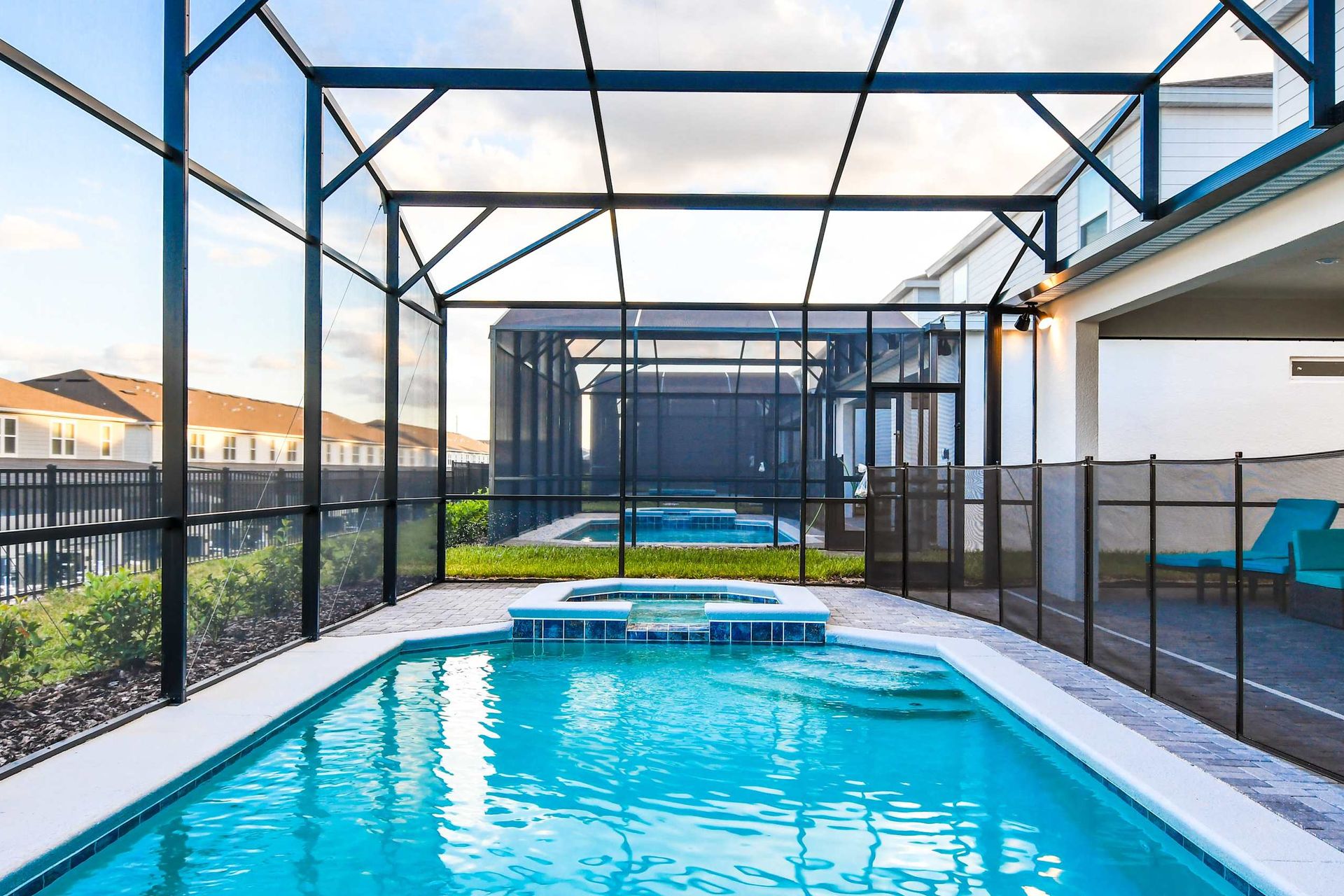 Relaxing screened pool and spa area with lounge chairs and private outdoor space
