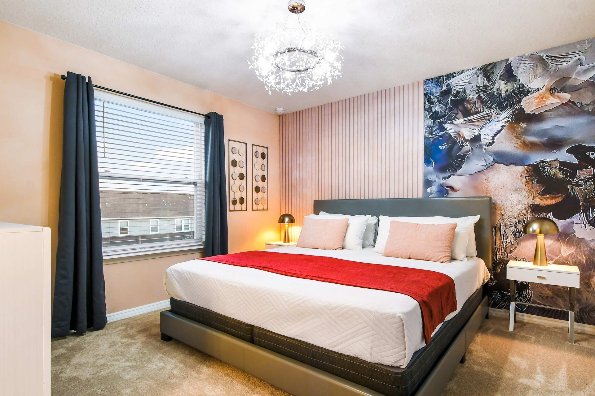 Artful bedroom oasis with cozy king bed, dreamy lighting, and unique mural wall
