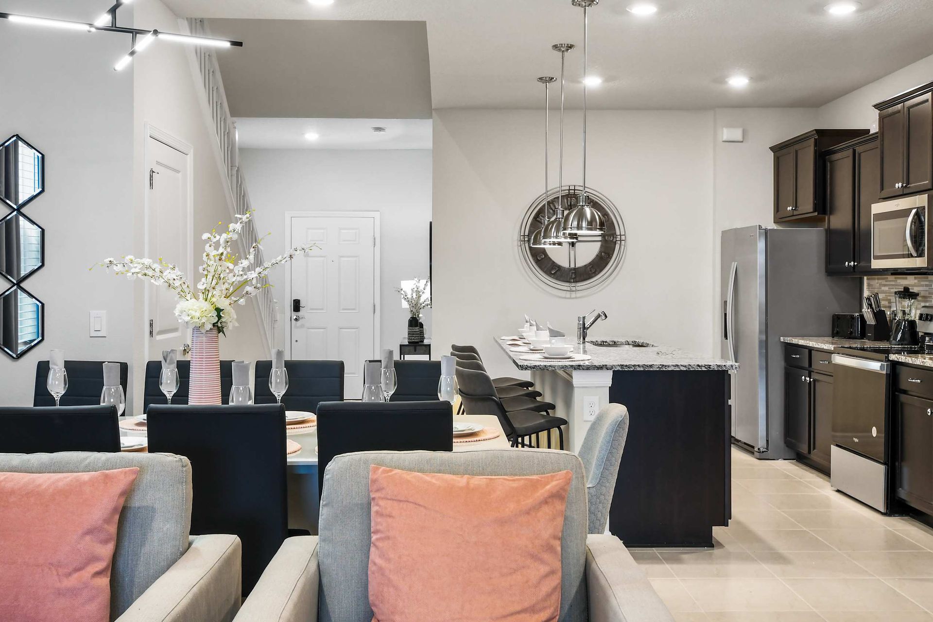 Elegant dining and kitchen area with modern lighting, sleek island, and cozy vibes!

