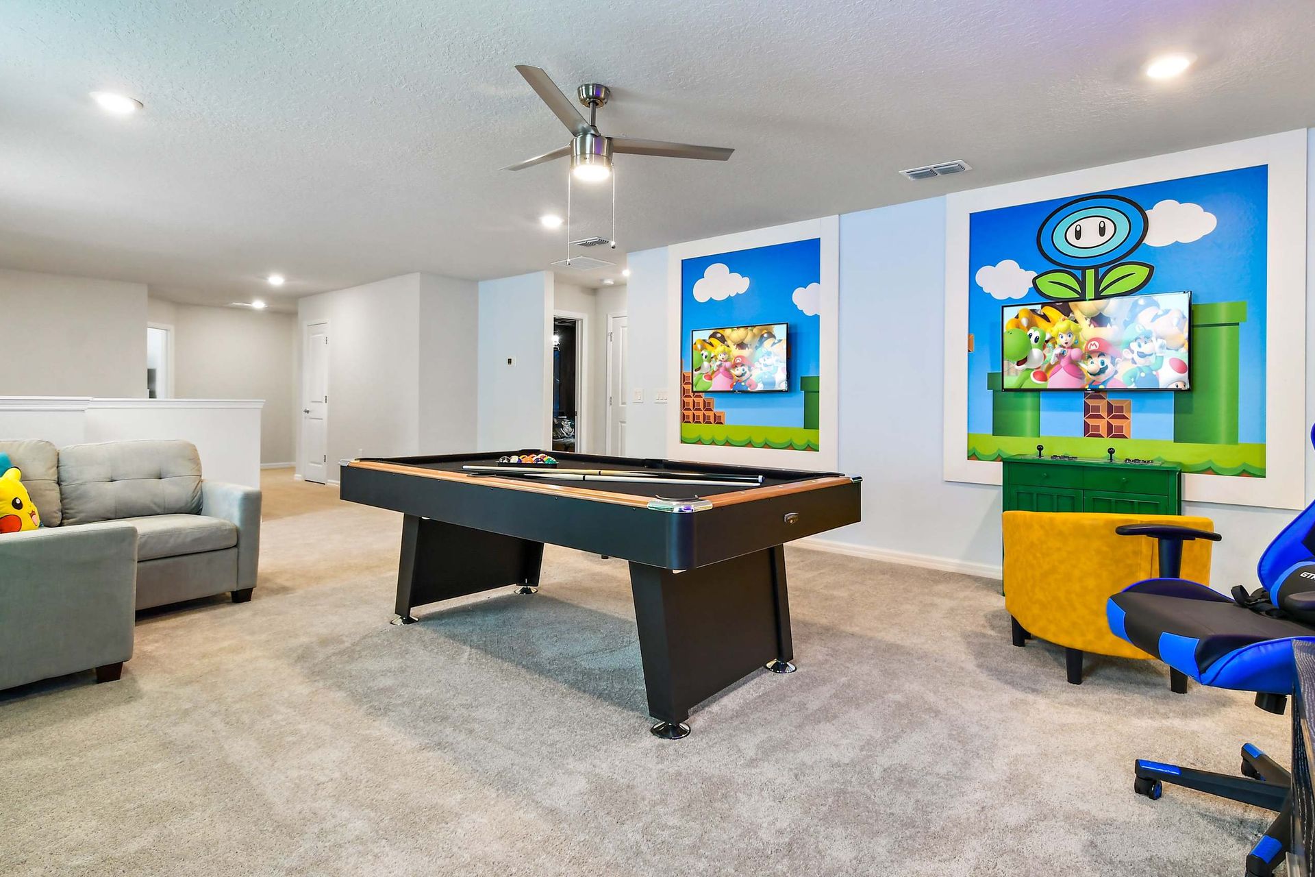 Colorful Mario-themed game loft with pool table, gaming chairs, and cozy seating!
