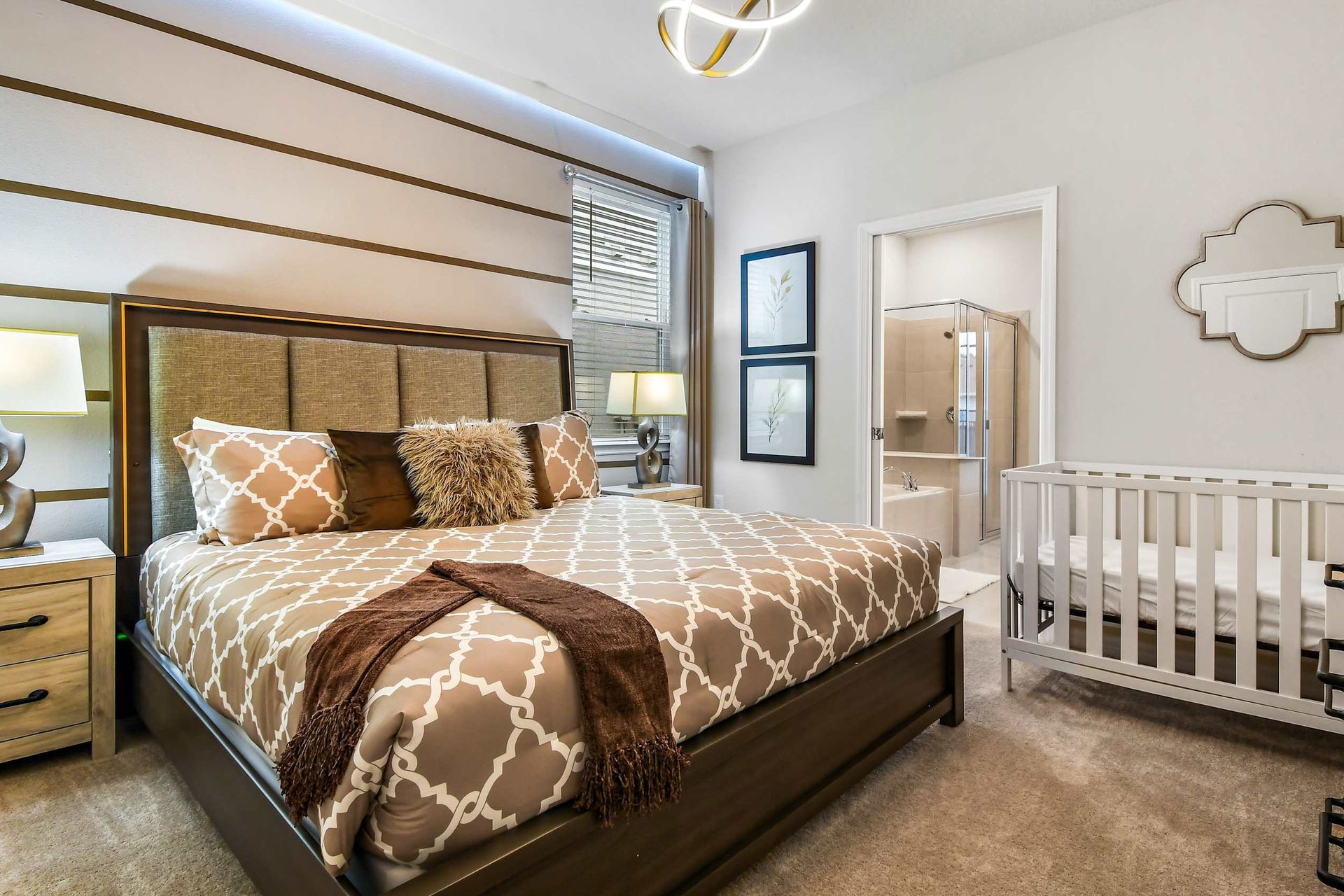 The master bedroom features a luxuriously large king bed with a crib