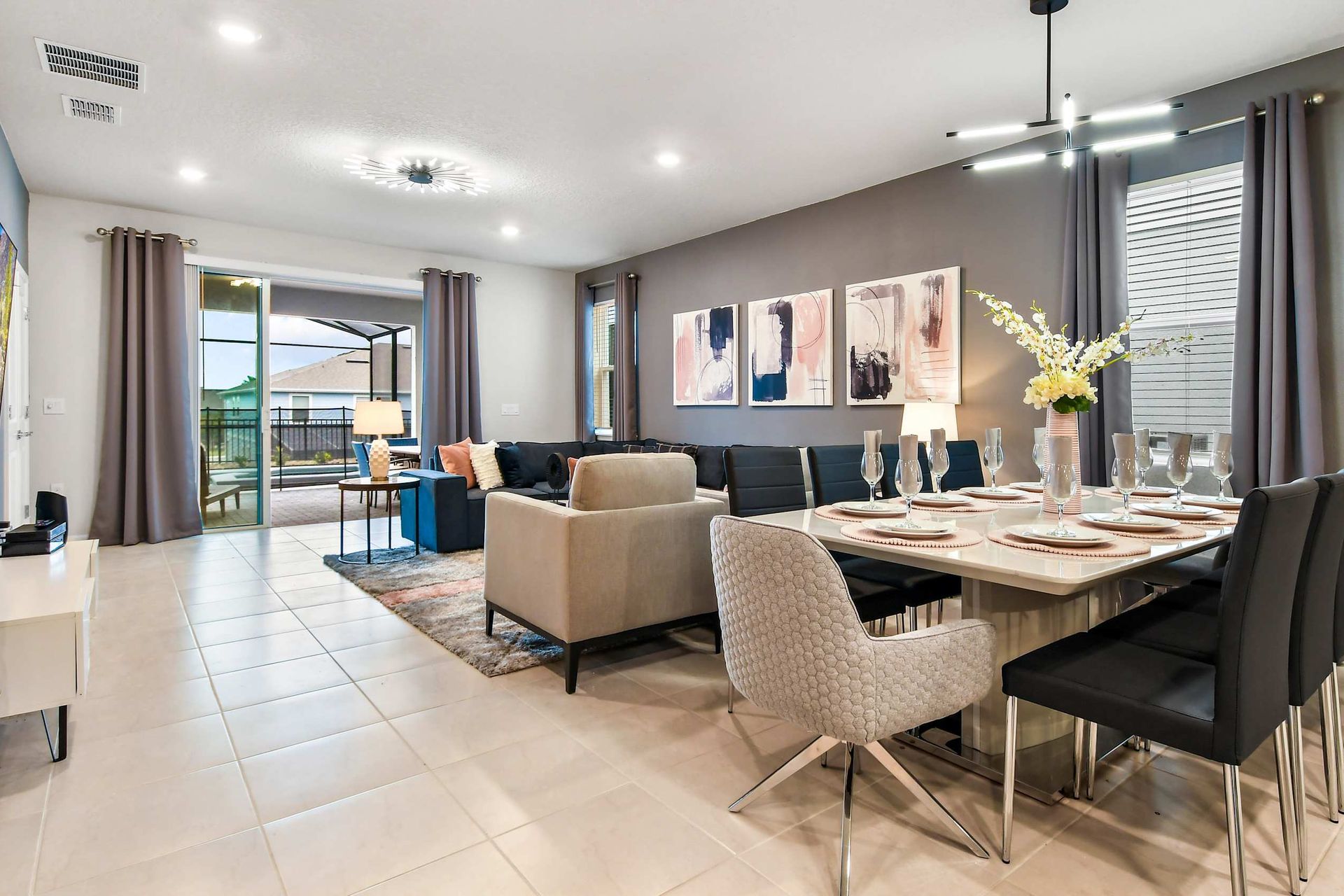 Modern open-concept living and dining area with stylish decor and patio access!
