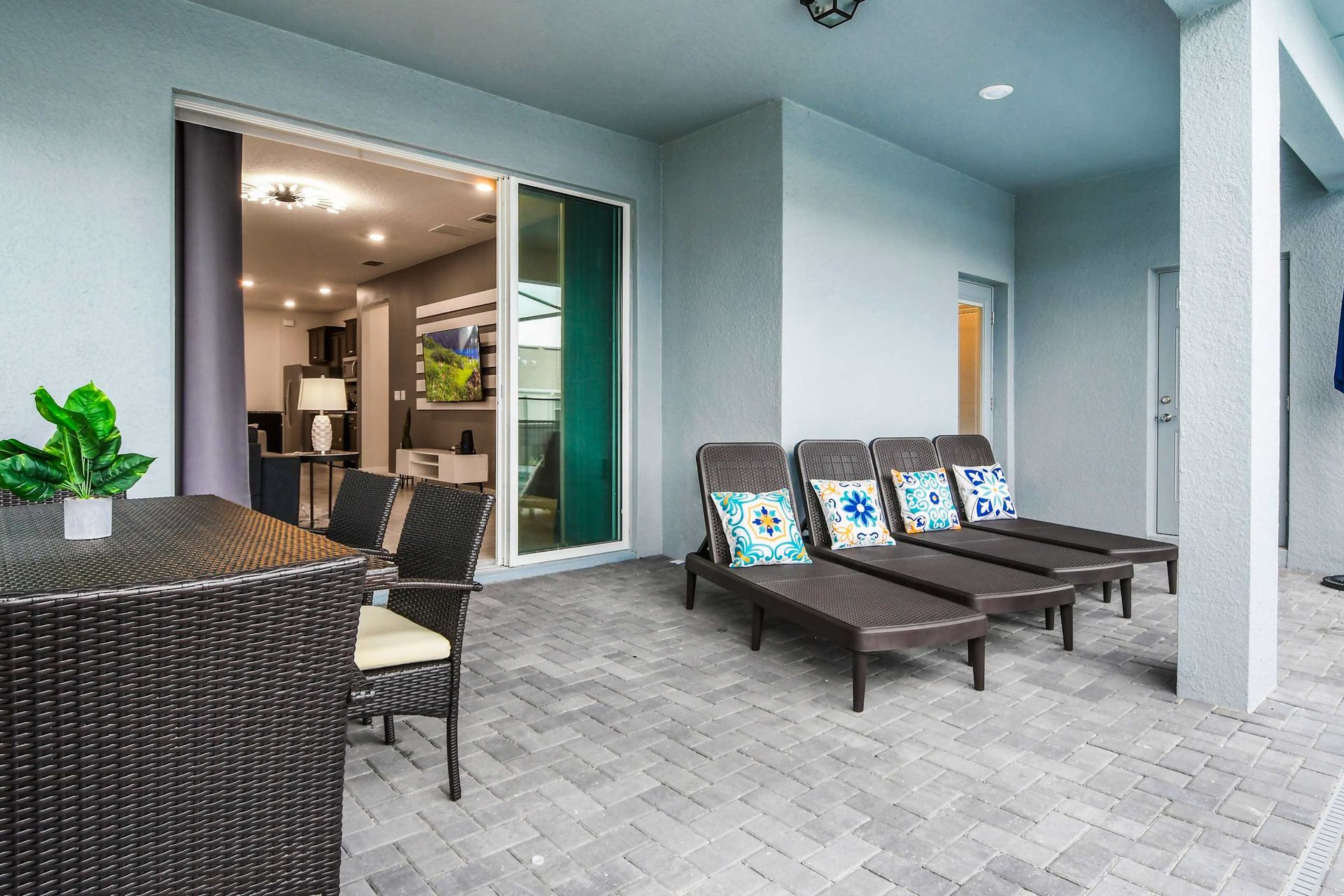 Spacious covered patio with dining area and loungers for ultimate outdoor relaxation
